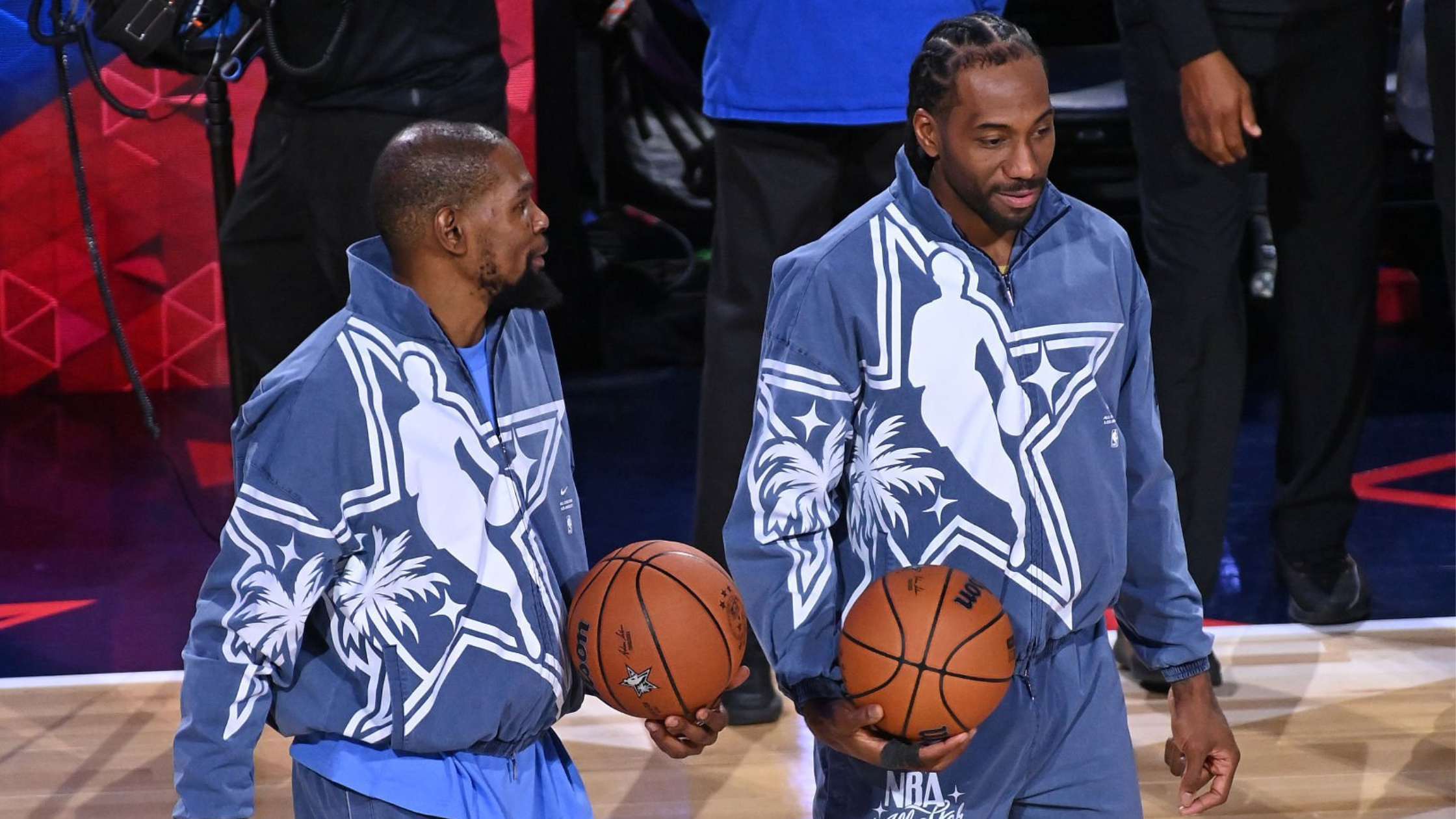 Kevin Durant wearing slate blue NBA All-Star 2026 warm-up jacket with white star and palm tree graphics