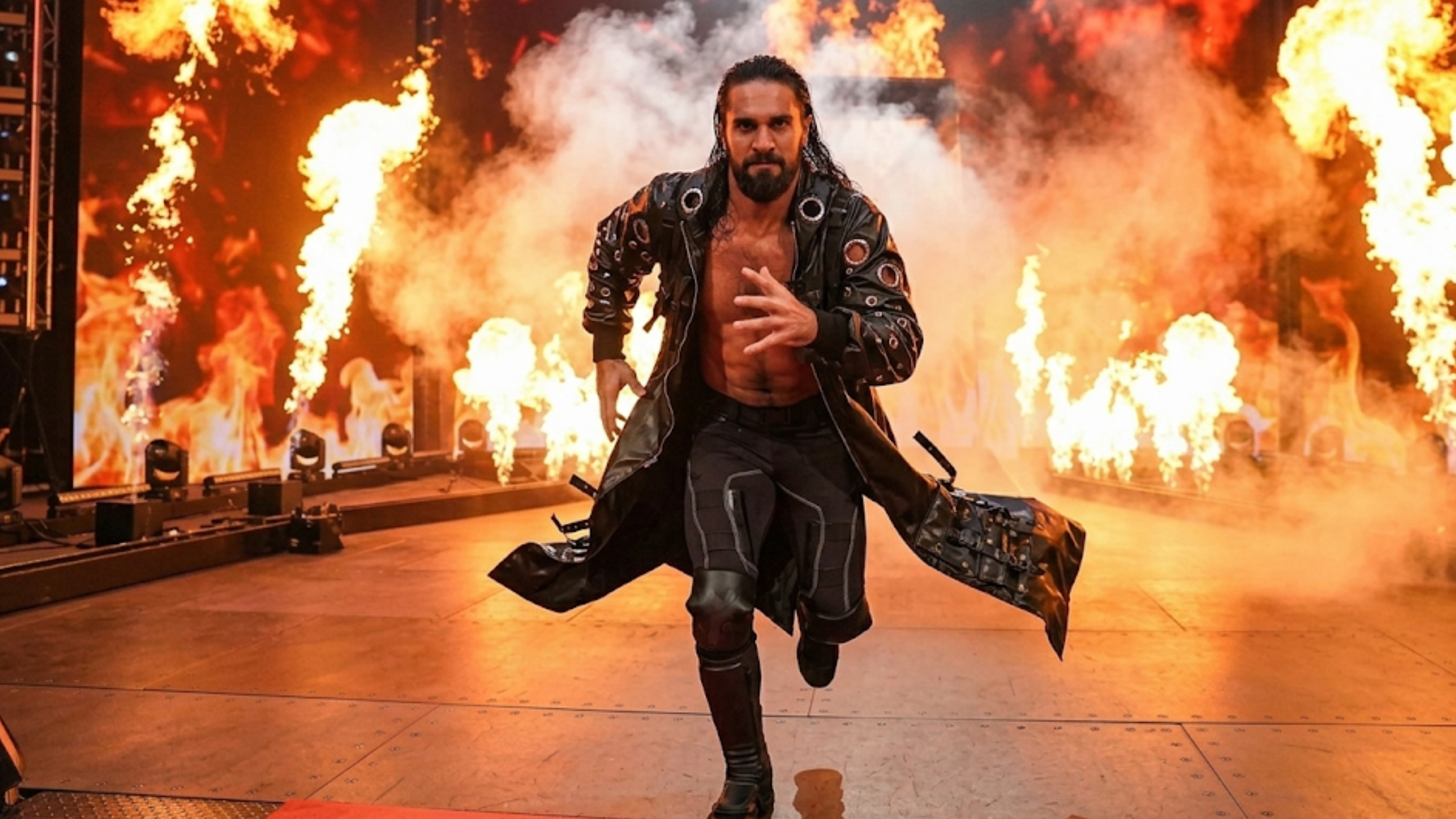 Seth Rollins WrestleMania 42 black leather longline trench coat with tactical cargo pockets, silver grommet detailing, and hooded dramatic design