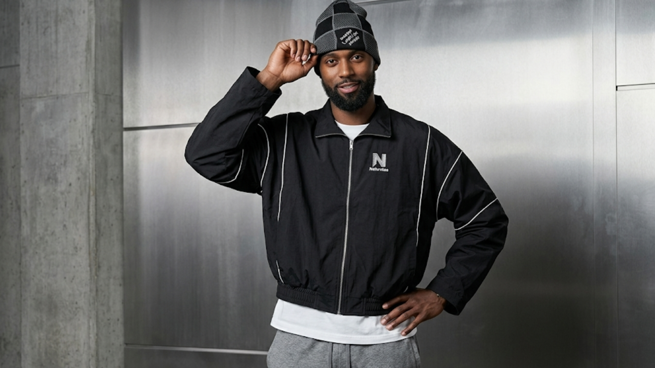 Bobby Portis Milwaukee Bucks vs Detroit Pistons black warm-up jacket with white geometric piping, silver zipper, and oversized athletic fit