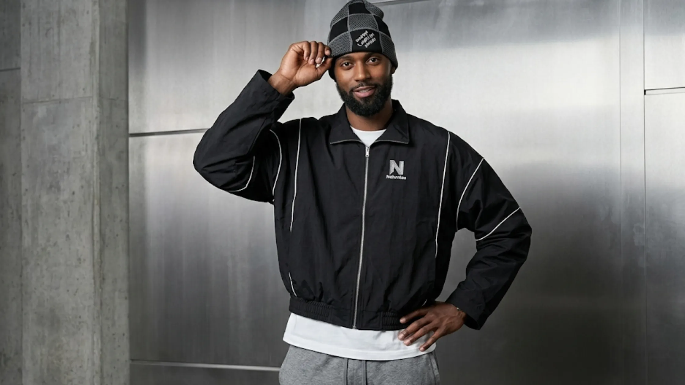Bobby Portis Milwaukee Bucks vs Detroit Pistons black warm-up jacket with white geometric piping, silver zipper, and oversized athletic fit