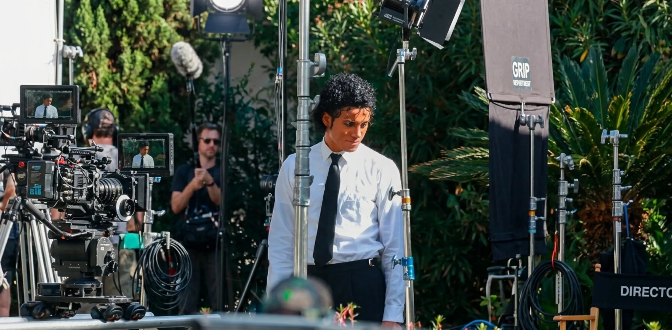 Michael Jaafar Jackson wearing a white slim-fit button-down shirt with barrel cuffs, cinematic style outfit from the film Michael, elegant minimalist formalwear look inspired by Michael Jackson legacy.