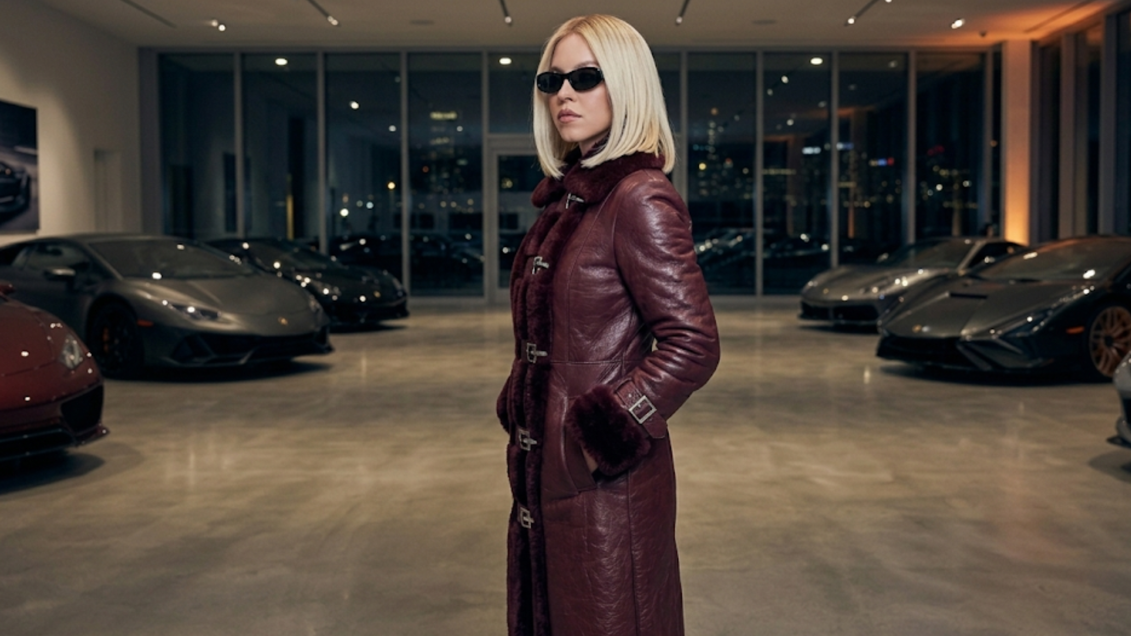 Sydney Sweeney burgundy leather trench coat with faux shearling trim and buckle-front belted design