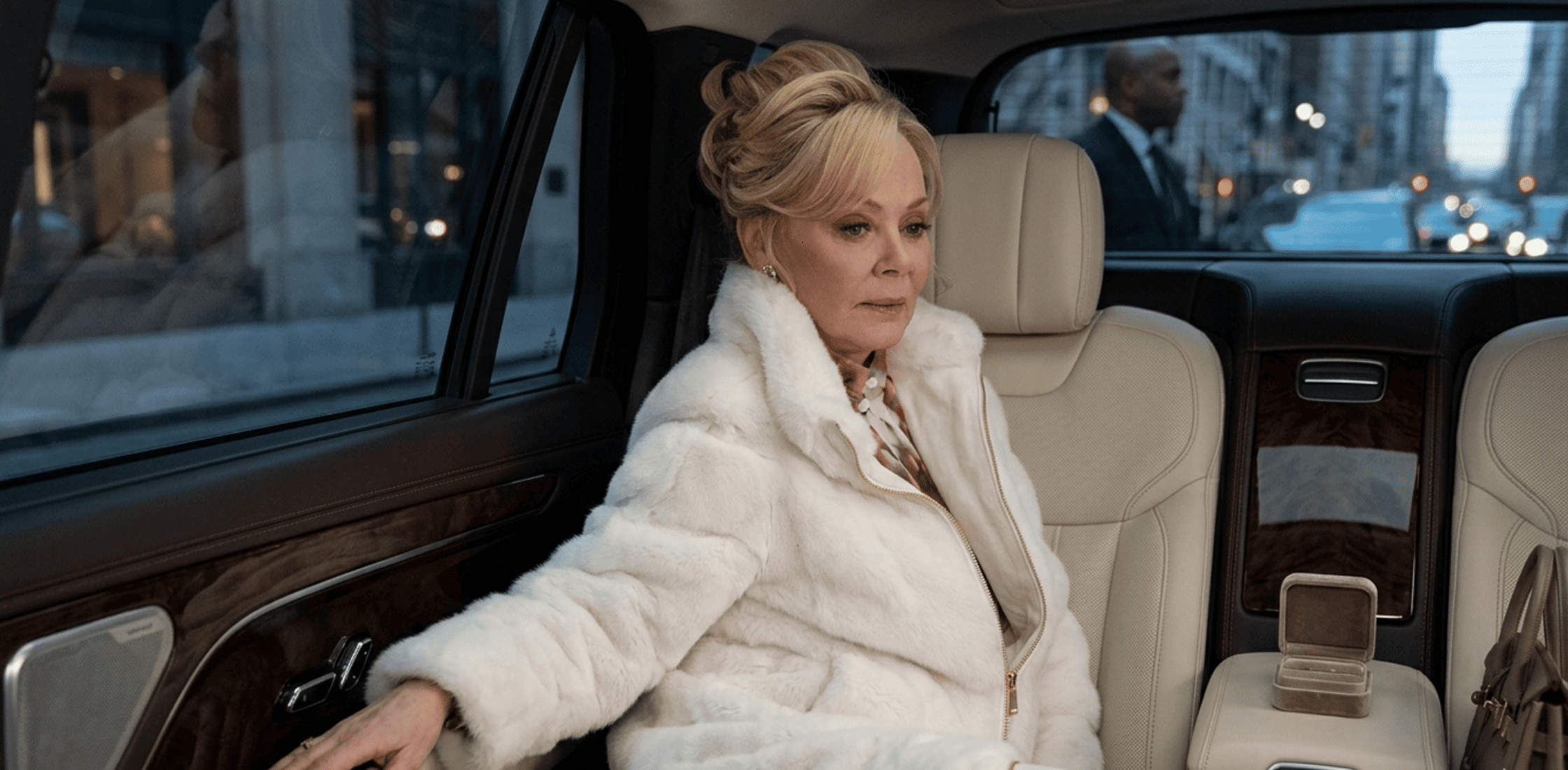 Hacks Season 5 Jean Smart faux fur slouch jacket in cream with oversized cocoon silhouette, chevron panel faux fur design, gold zipper, and high collar inspired by Deborah Vance style.