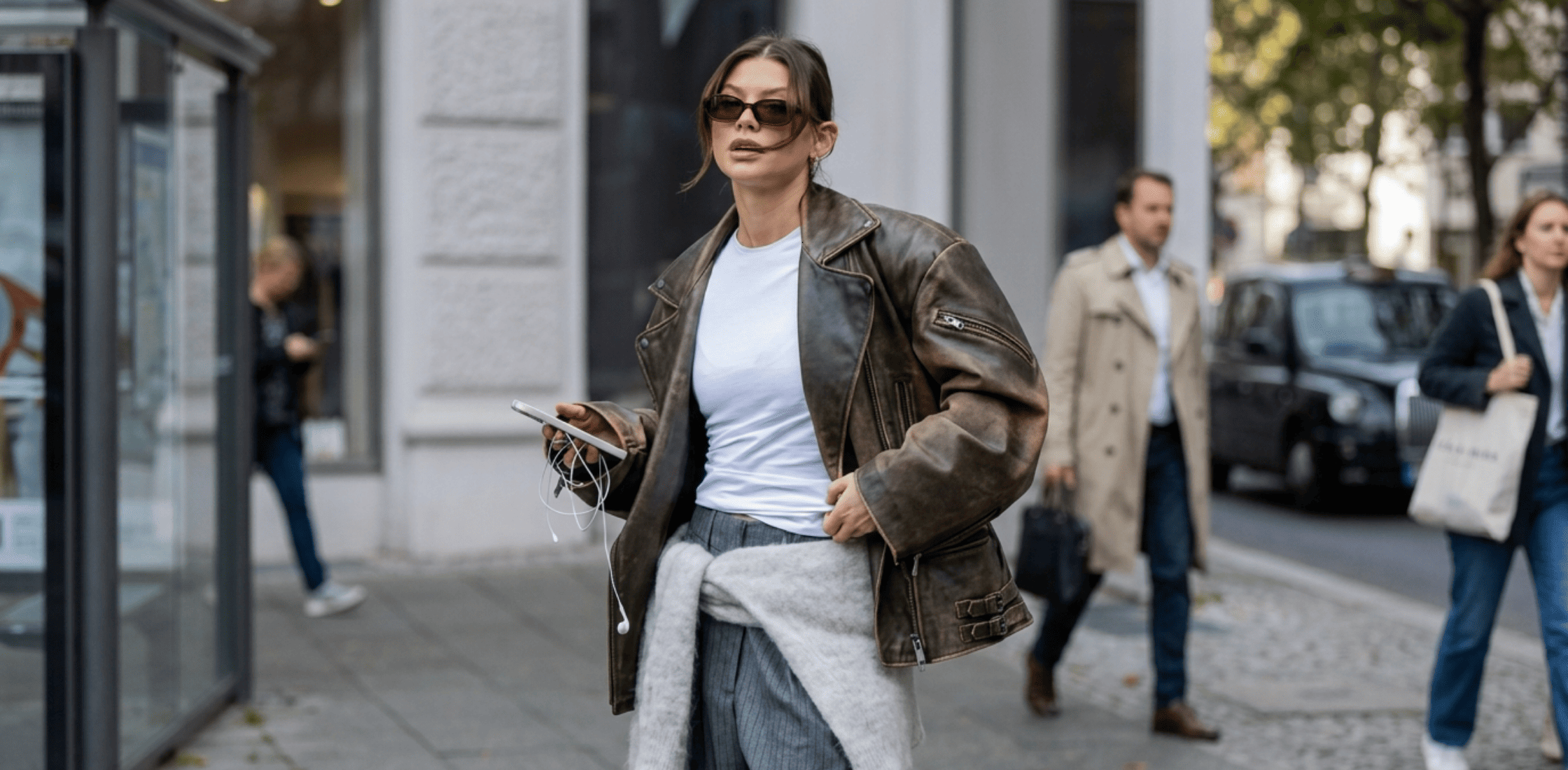 Oversized brown leather biker jacket inspired by Sophia Geiss Berlin 2025 featuring zipper sleeves, buckle hem detail, and vintage luxury finish.
