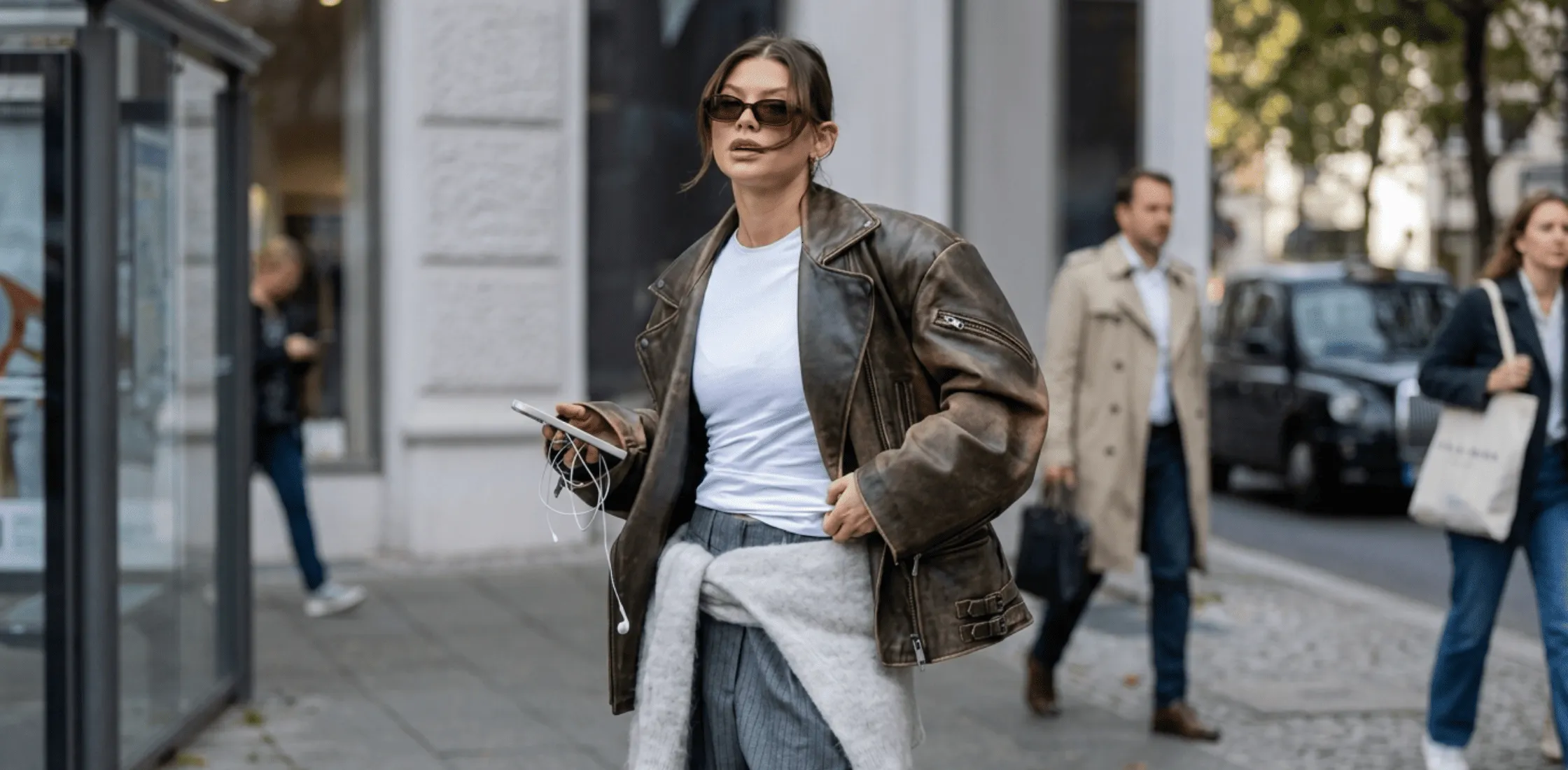 Oversized brown leather biker jacket inspired by Sophia Geiss Berlin 2025 featuring zipper sleeves, buckle hem detail, and vintage luxury finish.