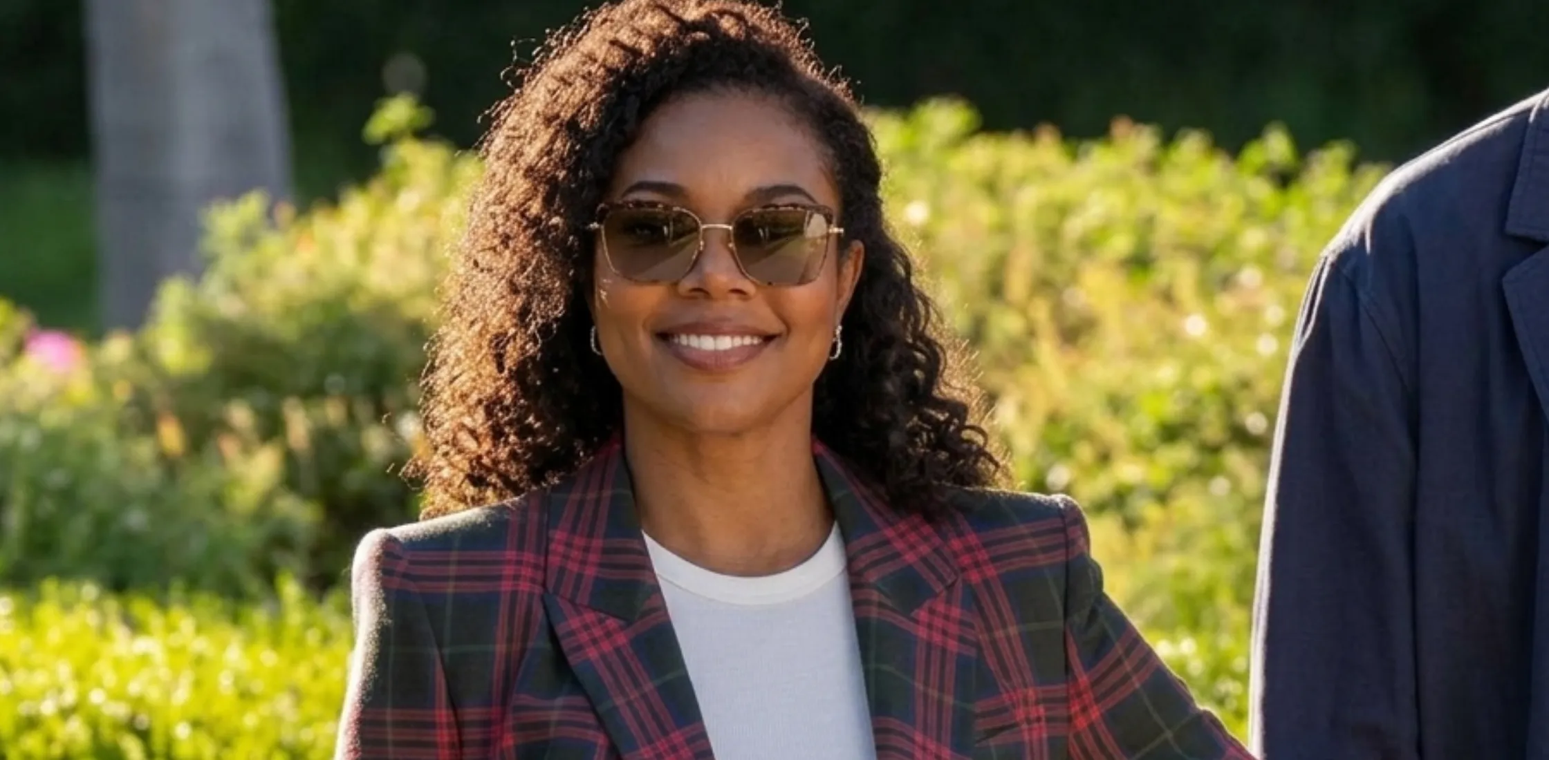 Karen Pittman wearing green and pink tartan plaid blazer as Dawn Edwards in FOREVER 2025