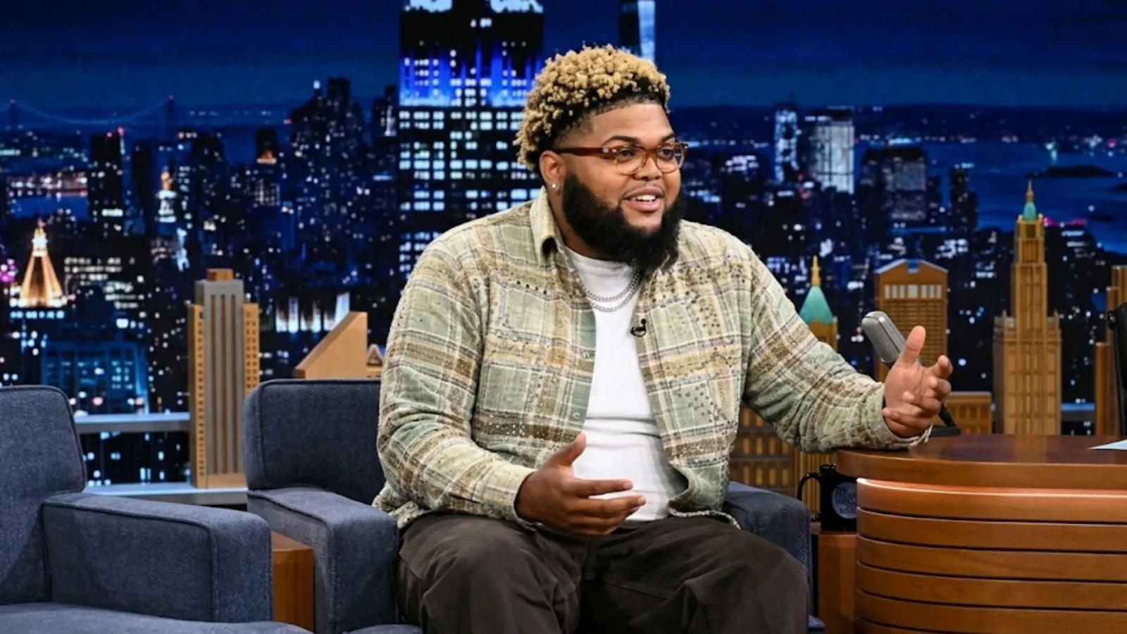 Druski wearing plaid shacket with olive green tan brown pattern and sequin embellishments inspired by The Tonight Show Season 13 appearance