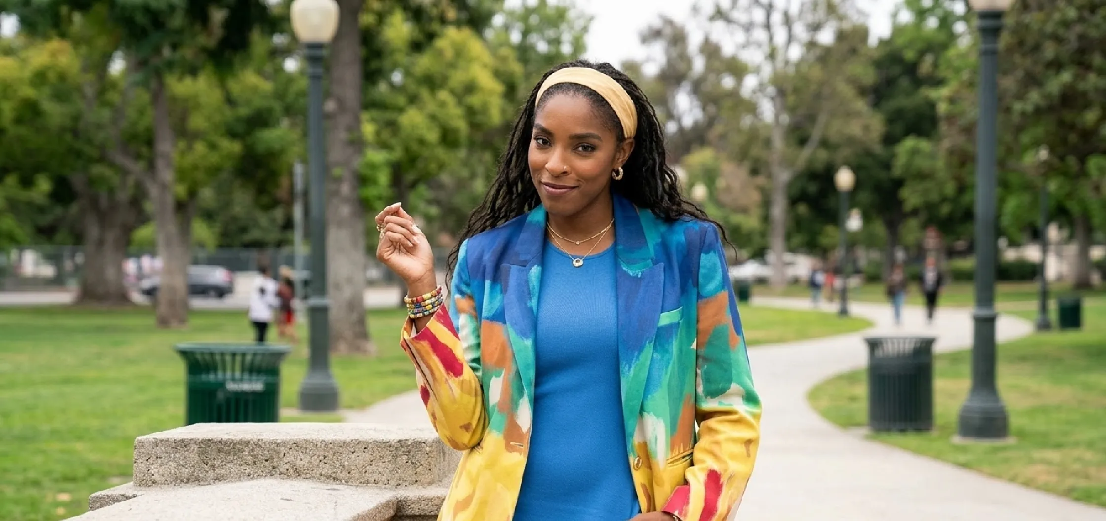 Jessica Williams wearing a multicolor abstract watercolor printed blazer in Shrinking Season 3 Episode 3x03, featuring bold painterly patterns and structured tailoring