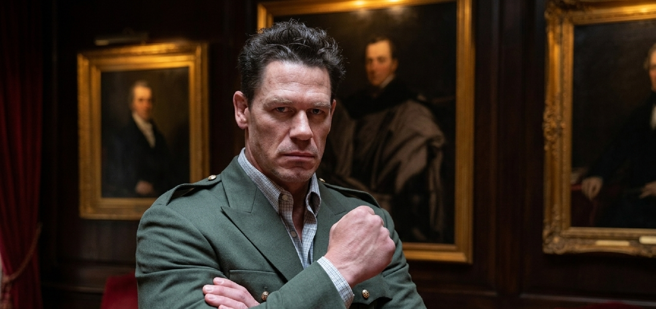 John Cena Vacation Friends 2 green military-inspired blazer featuring olive wool blend fabric, peak lapels, epaulettes with silver buttons, four-pocket field jacket design, and structured tailoring.