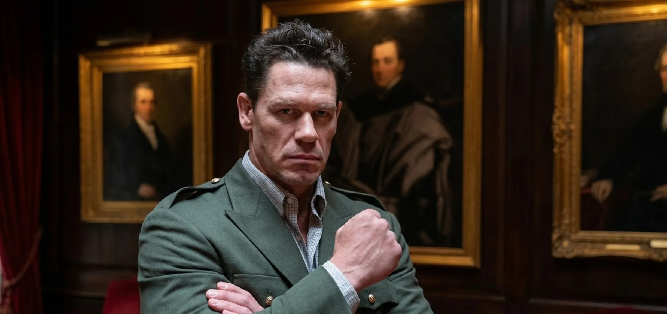 John Cena Vacation Friends 2 green military-inspired blazer featuring olive wool blend fabric, peak lapels, epaulettes with silver buttons, four-pocket field jacket design, and structured tailoring.