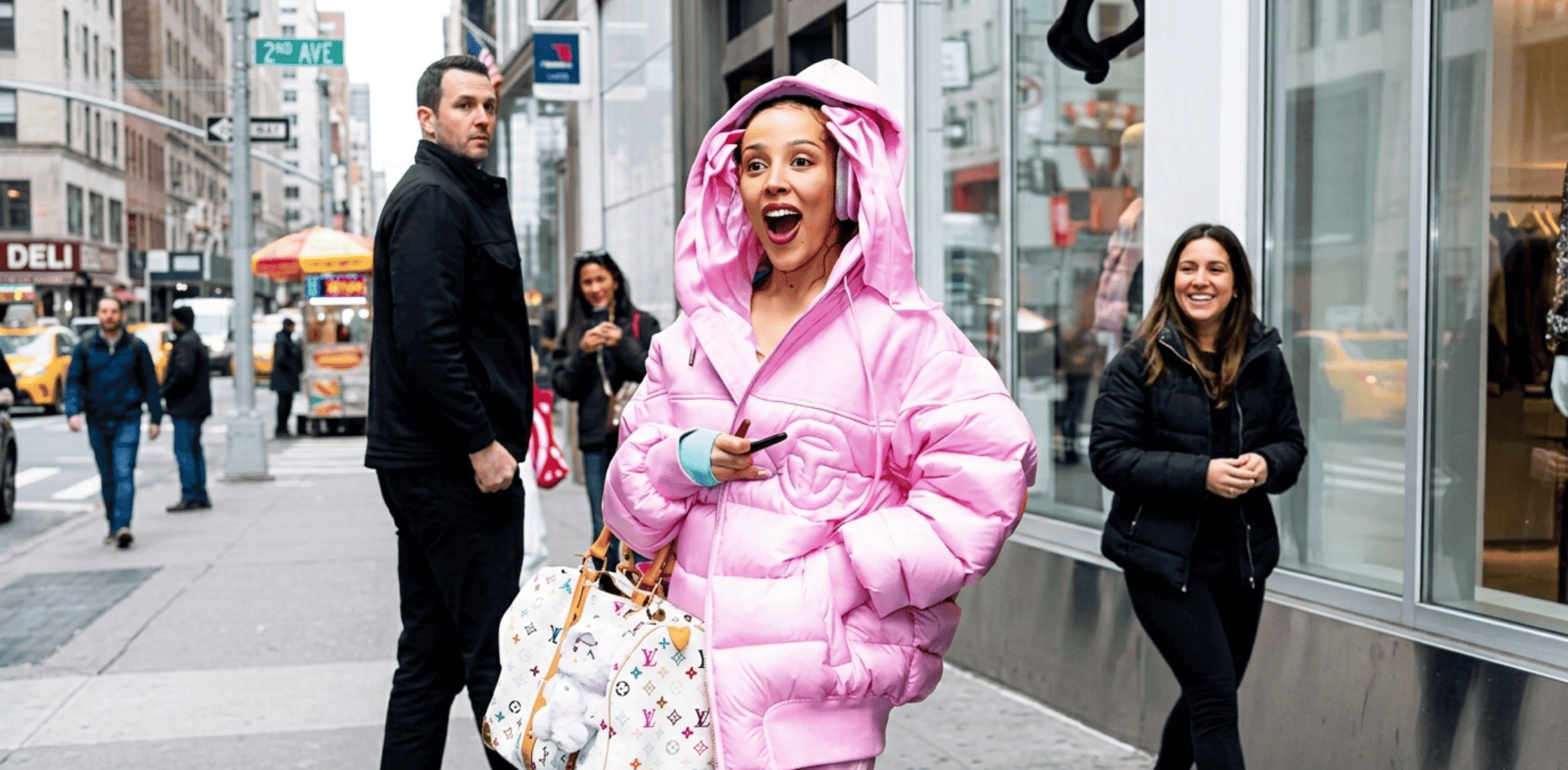 Doja Cat wearing a pink oversized Telfar puffer jacket with matching pants and Louis Vuitton x Takashi Murakami duffle bag in New York City before the Met Gala 2026