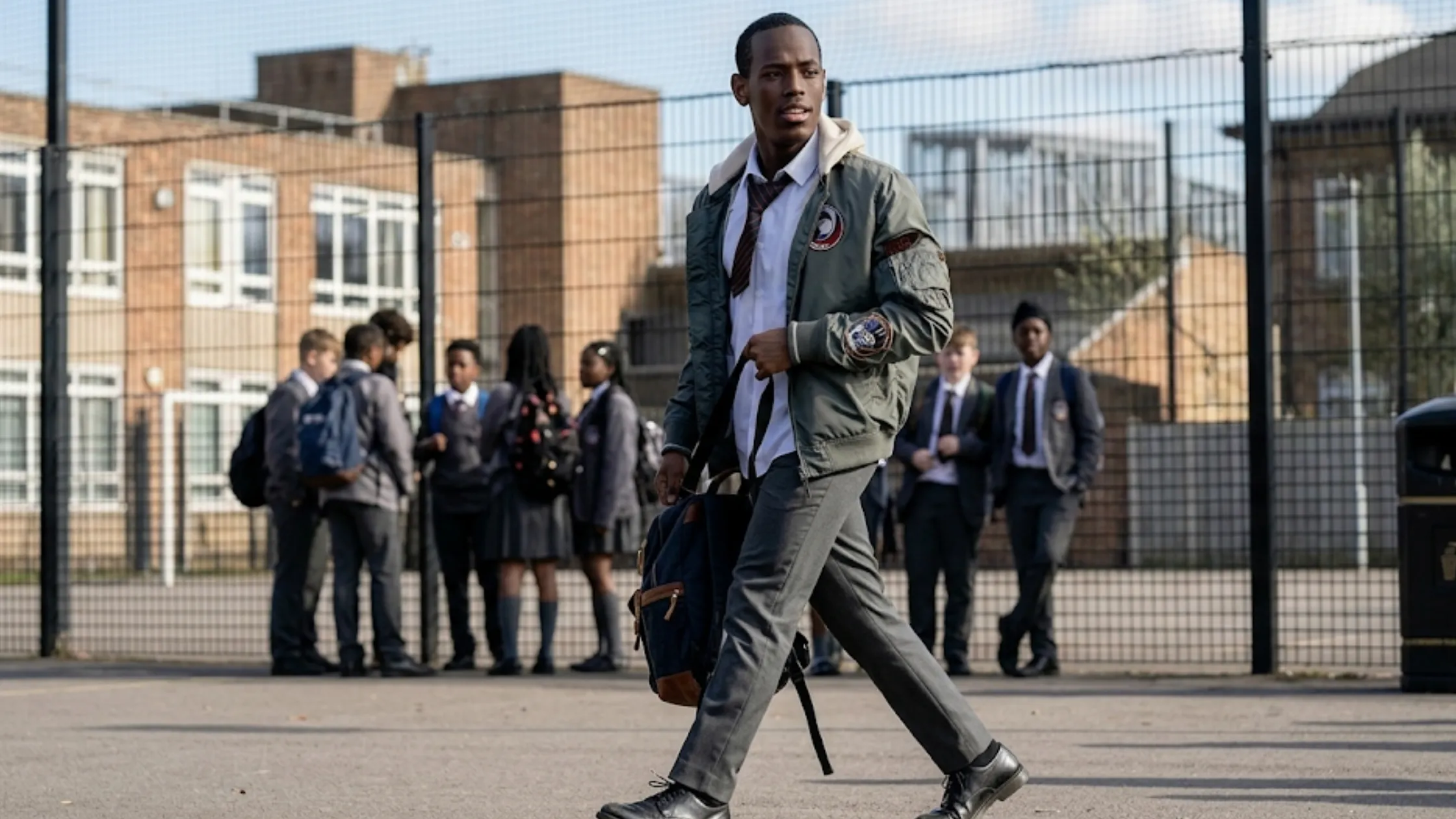 Micheal Ward Blue Story Marco 2025 slate grey MA-1 bomber jacket with cream hood and military patch embroidery