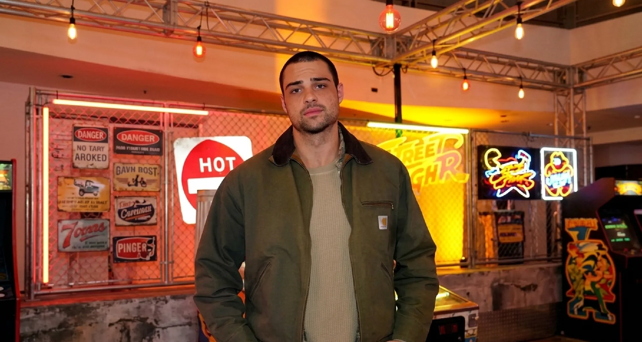 Noah Centineo wearing green Detroit canvas jacket at Street Fighter trailer launch party