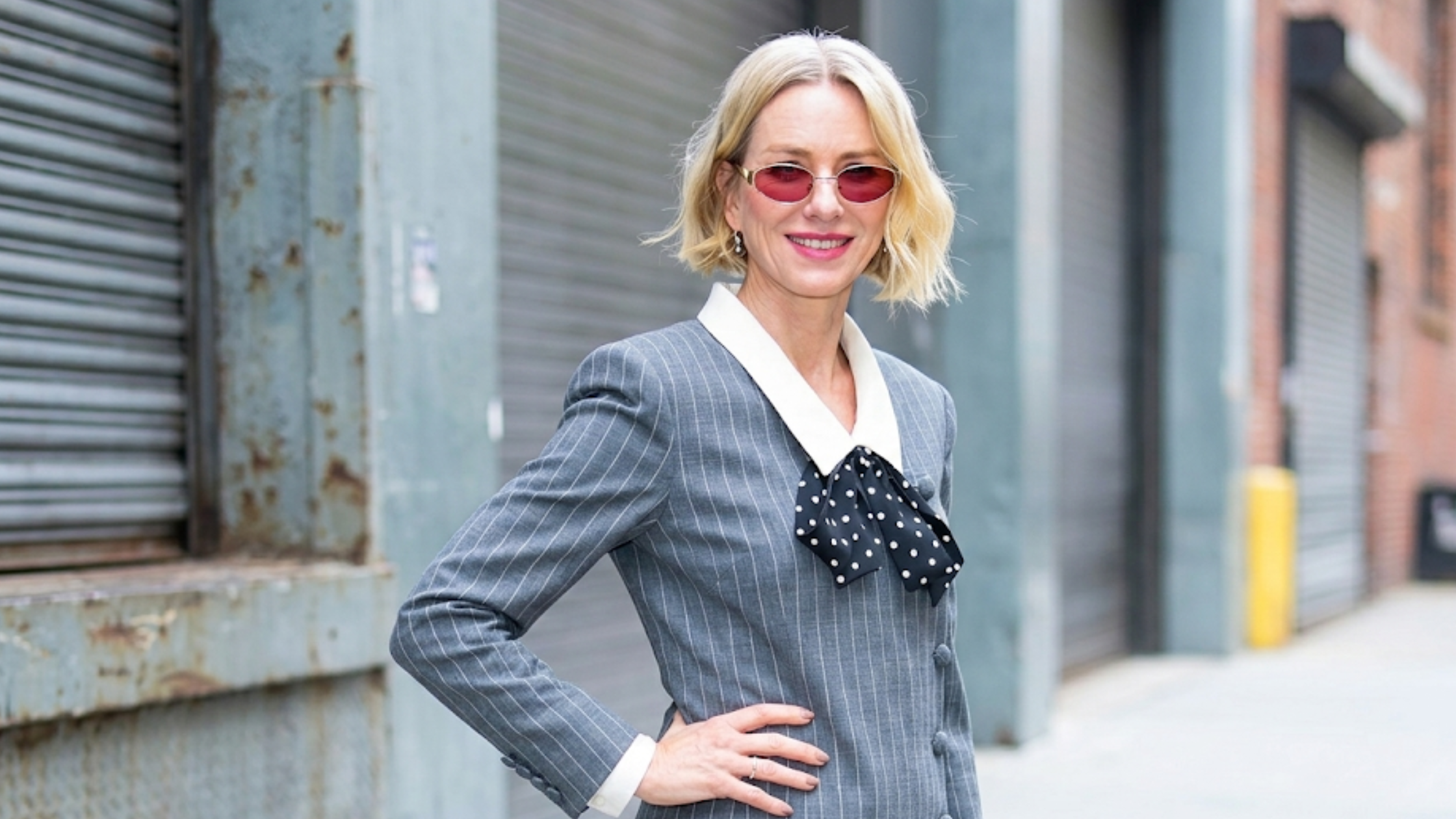 Naomi Watts ABC Studios NYC 2026 charcoal grey pinstripe long coat with oversized white collar and polka dot bow detail