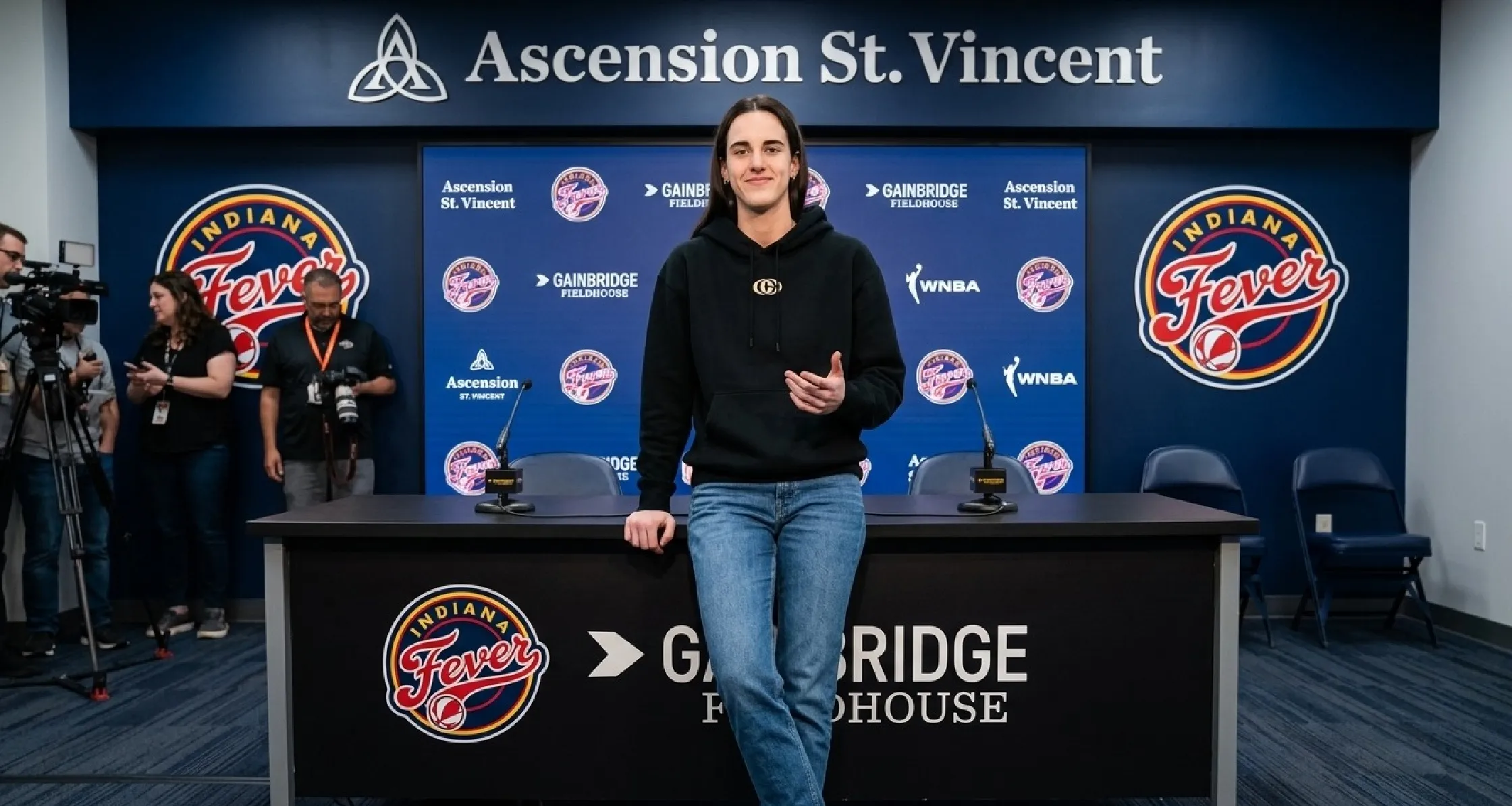 Caitlin Clark wearing a minimalist black pullover hoodie during the Indiana Fever 2025 exit interview