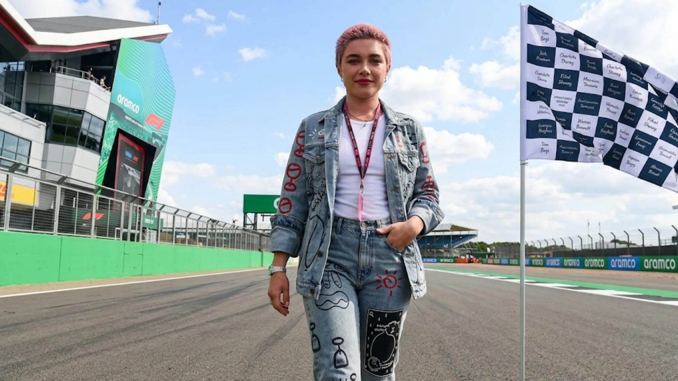 Florence Pugh F1 Silverstone distressed light blue denim jacket with red hand-painted graffiti artwork and black sketch details