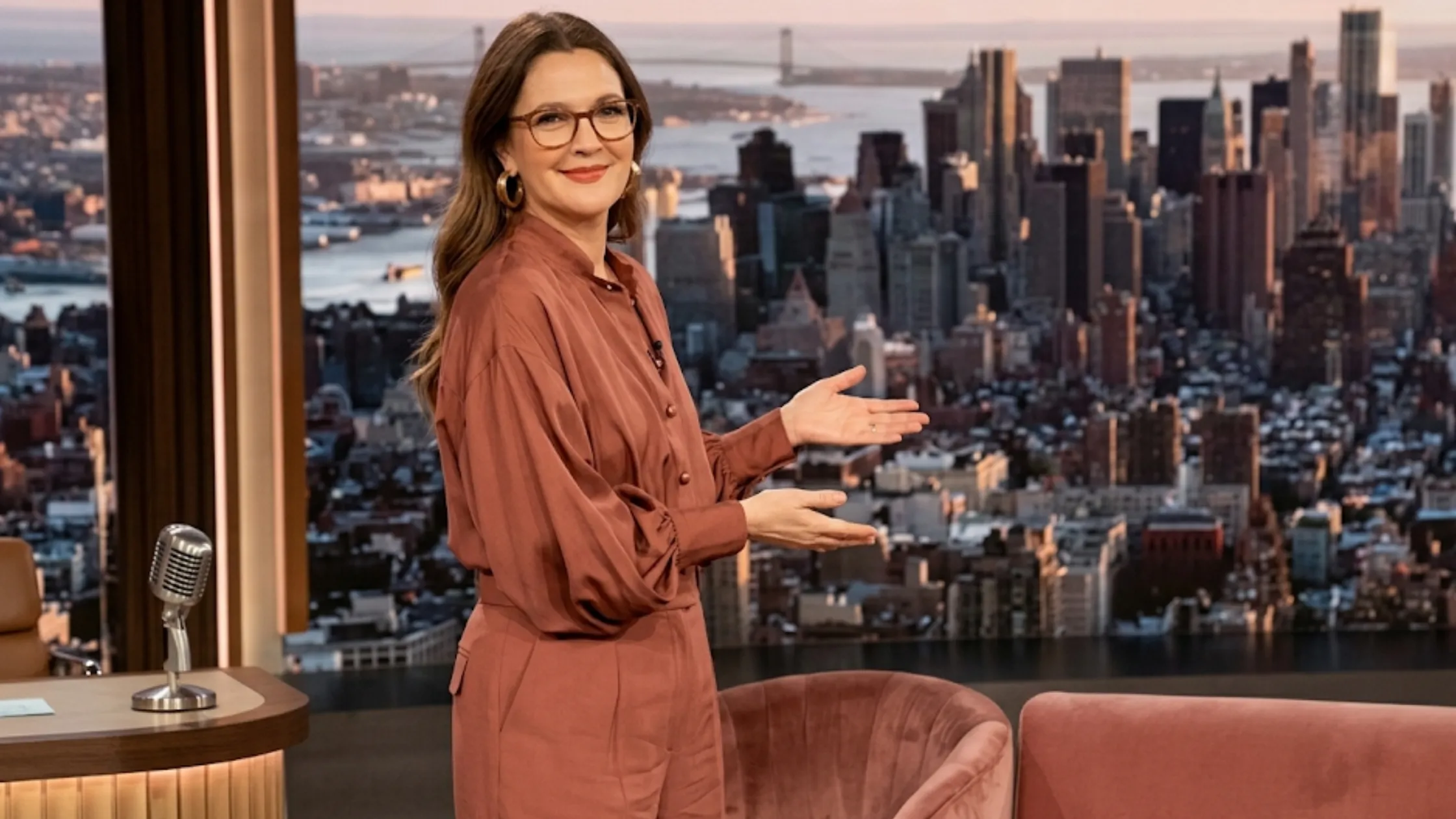 Drew Barrymore rust satin silk blouse with bishop sleeves and mock-neck collar on The Drew Barrymore Show 2025