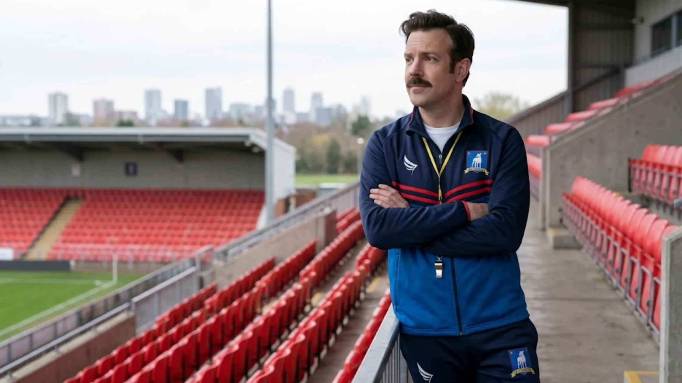 Ted Lasso Season 4 Jason Sudeikis blue tracksuit with chevron chest pattern and colorful stripe detailing