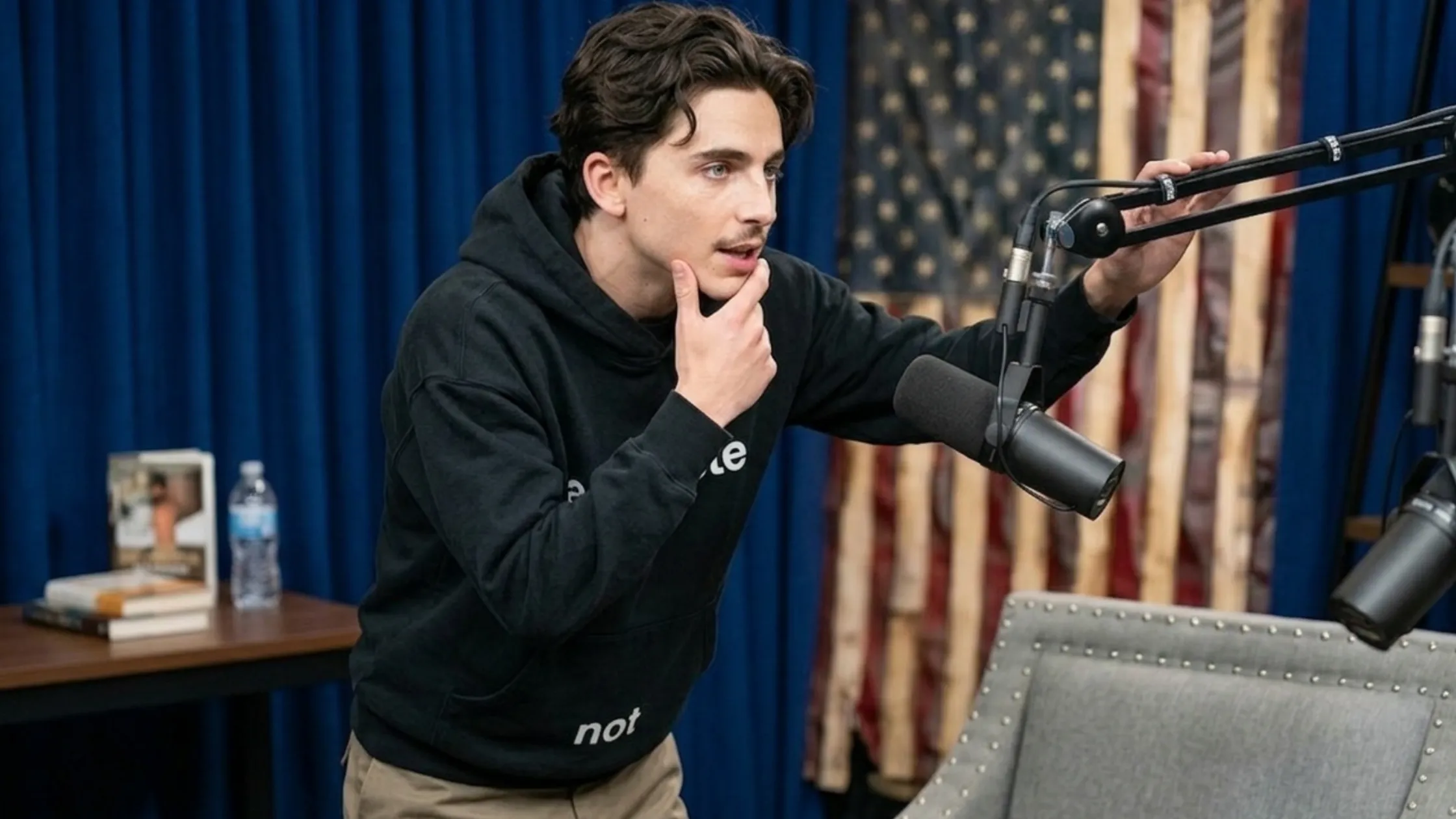 Timothée Chalamet A Complete Unknown black cropped boxy hoodie with white typography print and oversized fit streetwear