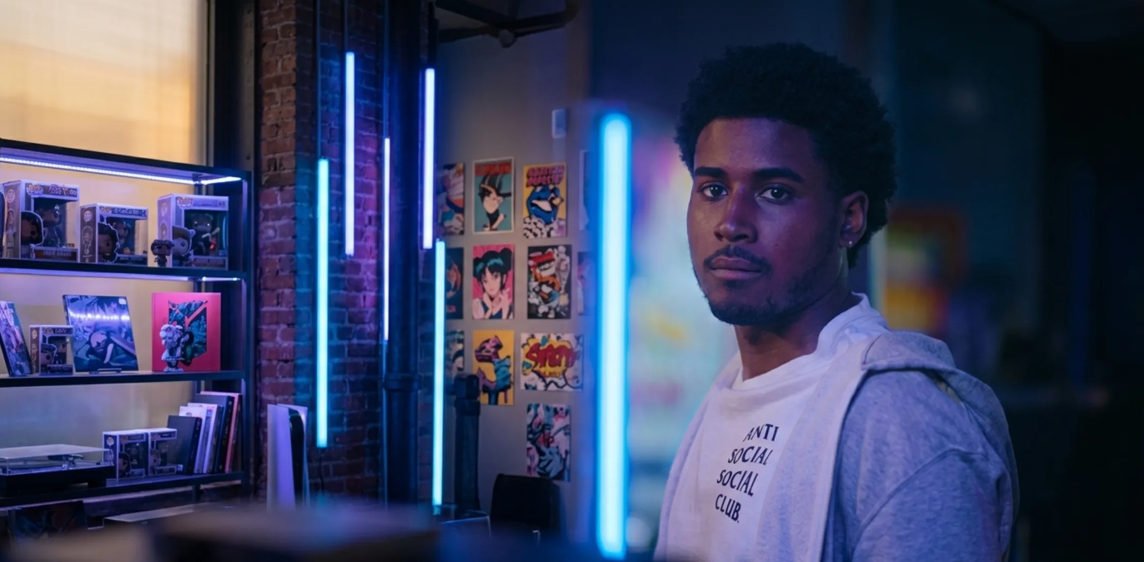 Justin Edwards wearing a white Anti Social Social Club T-shirt in Netflix’s Forever with a layered hoodie streetwear look.