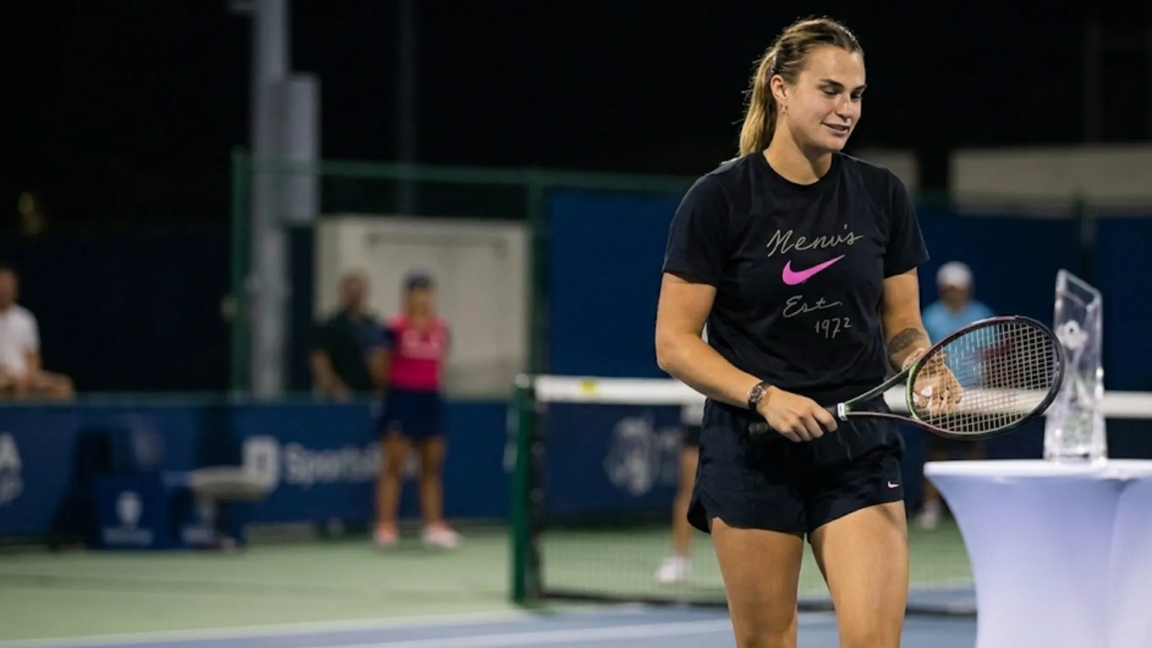 Aryna Sabalenka 2026 Miami Open black Nike graphic t-shirt with white script logo, pink Swoosh, and Est. 1972 heritage print