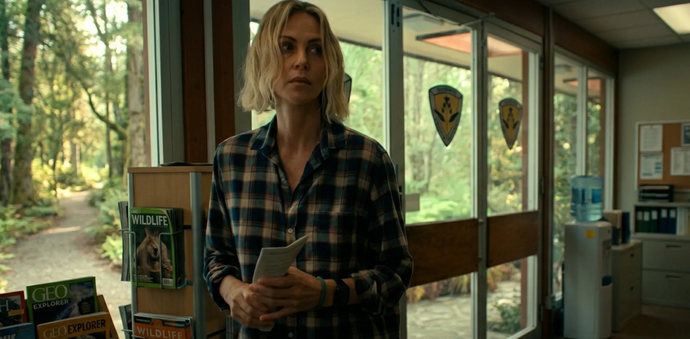 Apex 2026 Charlize Theron plaid flannel shirt in navy and cream check pattern, relaxed oversized fit cinematic style fashion shirt