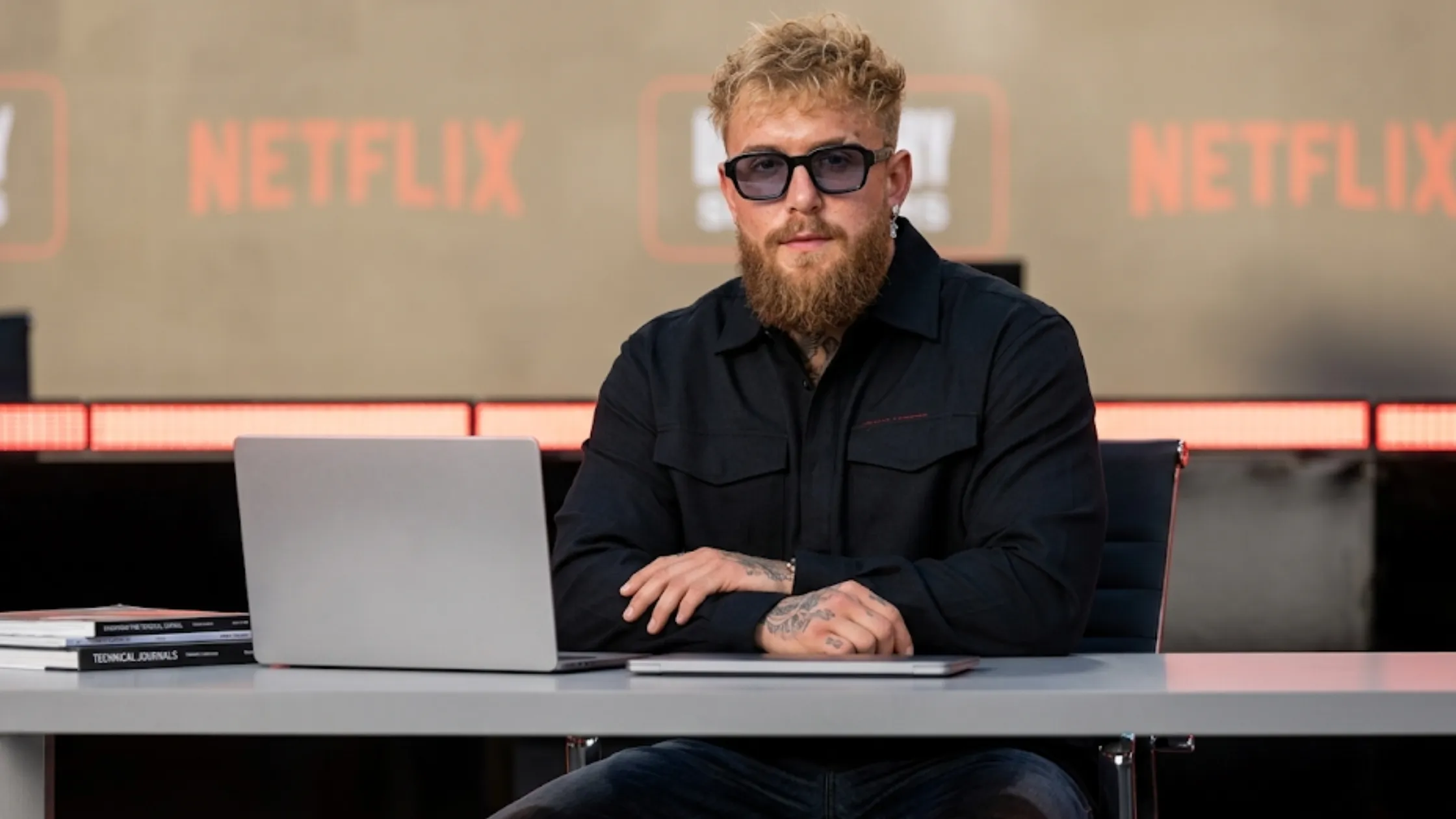 Jake Paul Netflix Ronda Rousey vs Gina Carano 2026 black utility shacket with crimson embroidered logo flap pockets oversized streetwear combat jacket