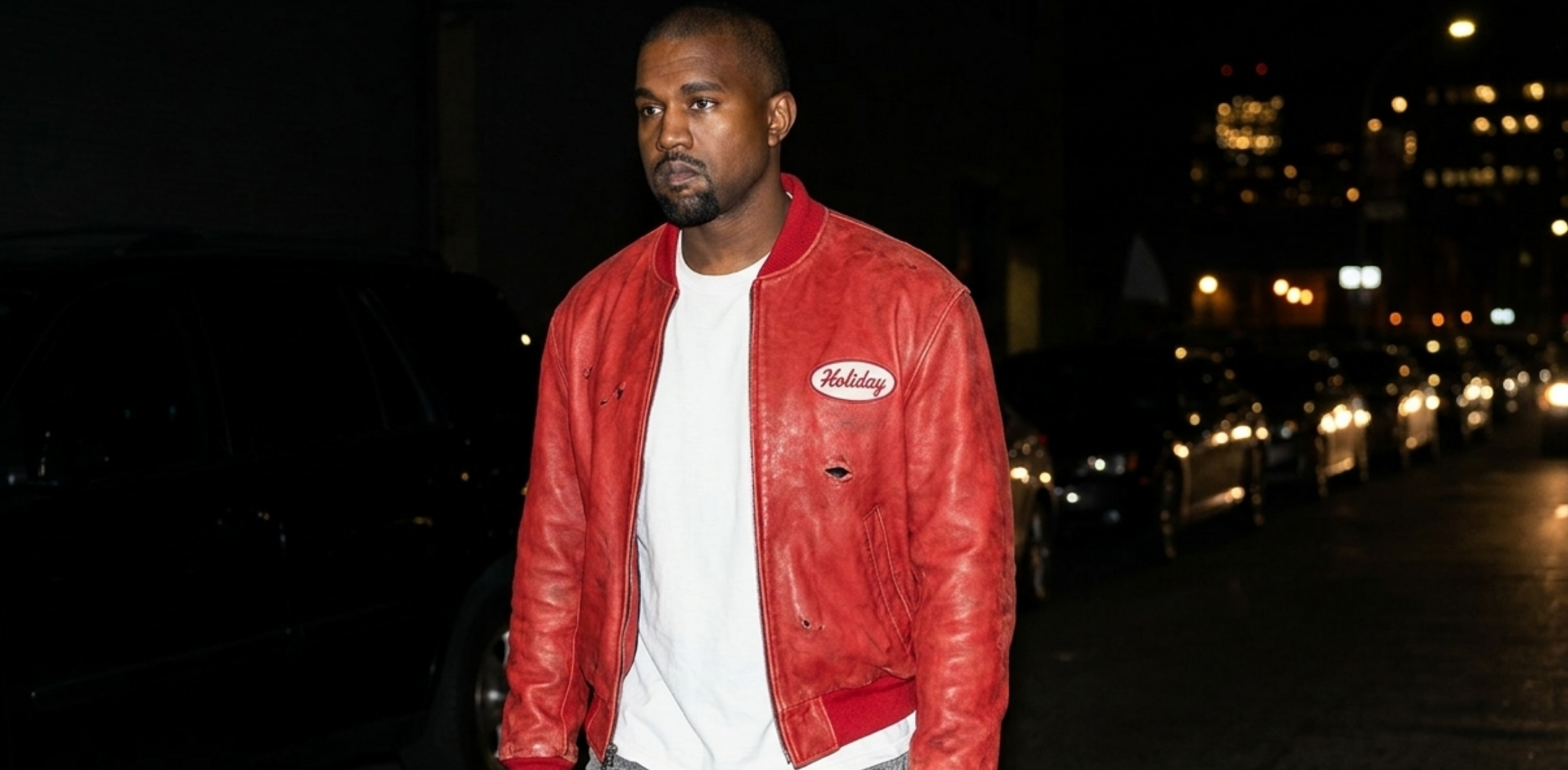 Kanye West red leather bomber jacket with distressed crimson finish and vintage Holiday Gas graphic detailing inspired by Michael Jackson style
