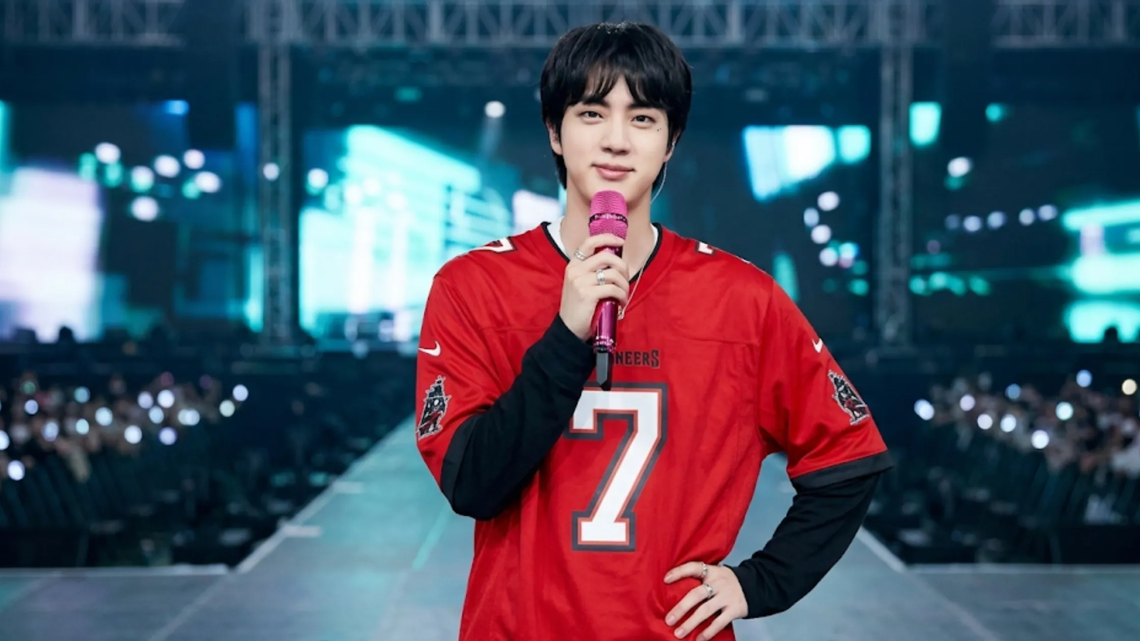 Jin Tampa Bay Buccaneers red oversized jersey with number 7, black trim V-neck collar, and chest “Buccaneers” graphic