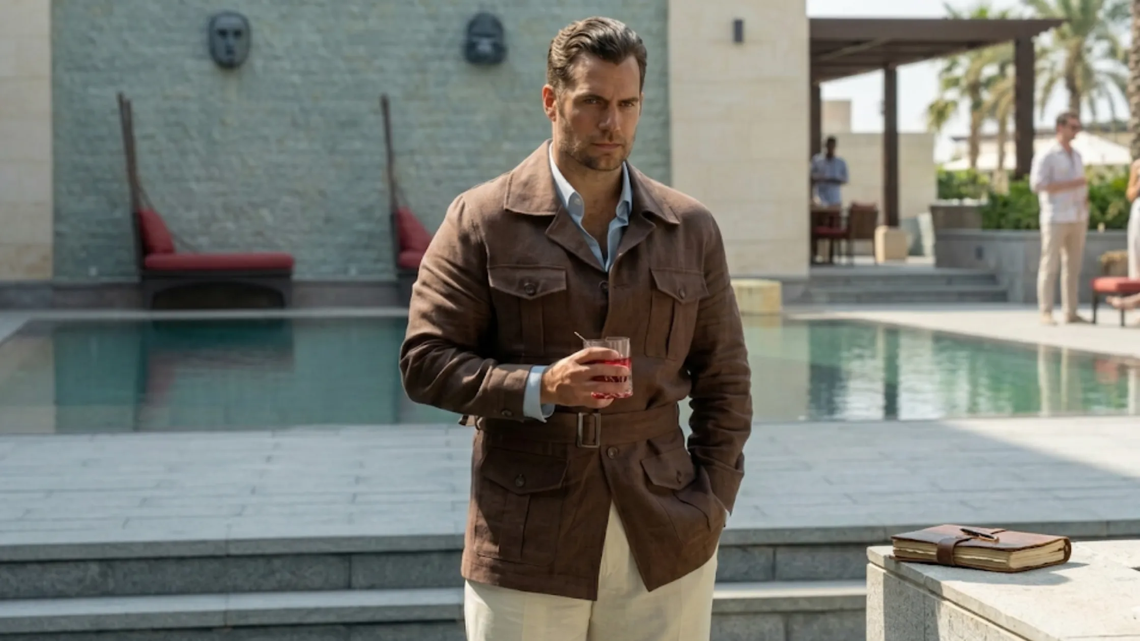 Henry Cavill In The Grey 2026 brown wool utility jacket with waist belt, camp collar, and flap pockets