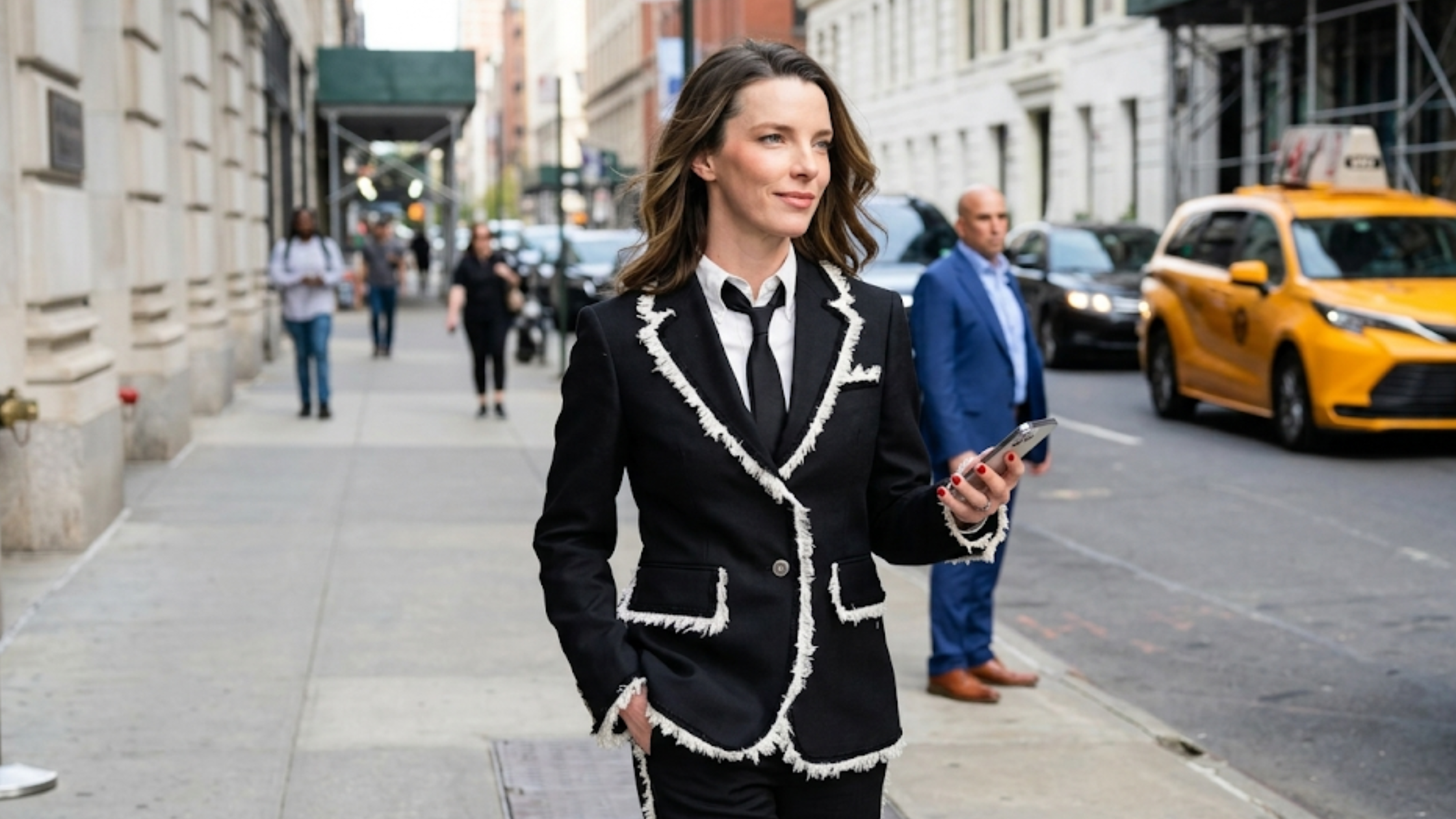 Betty Gilpin Office Romance New York Premiere 2026 black slim-fit blazer with white frayed contrast trim