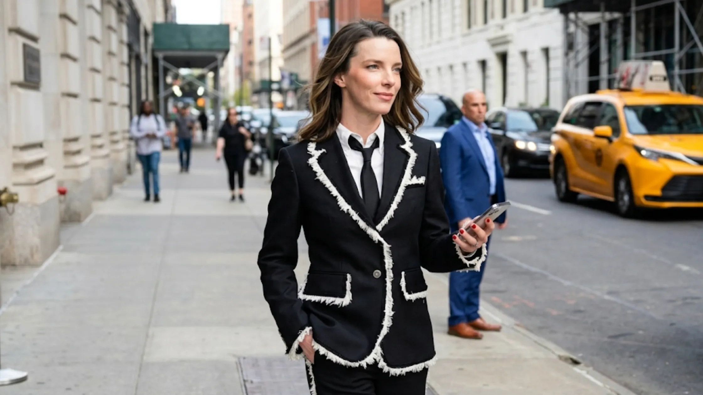 Betty Gilpin Office Romance New York Premiere 2026 black slim-fit blazer with white frayed contrast trim