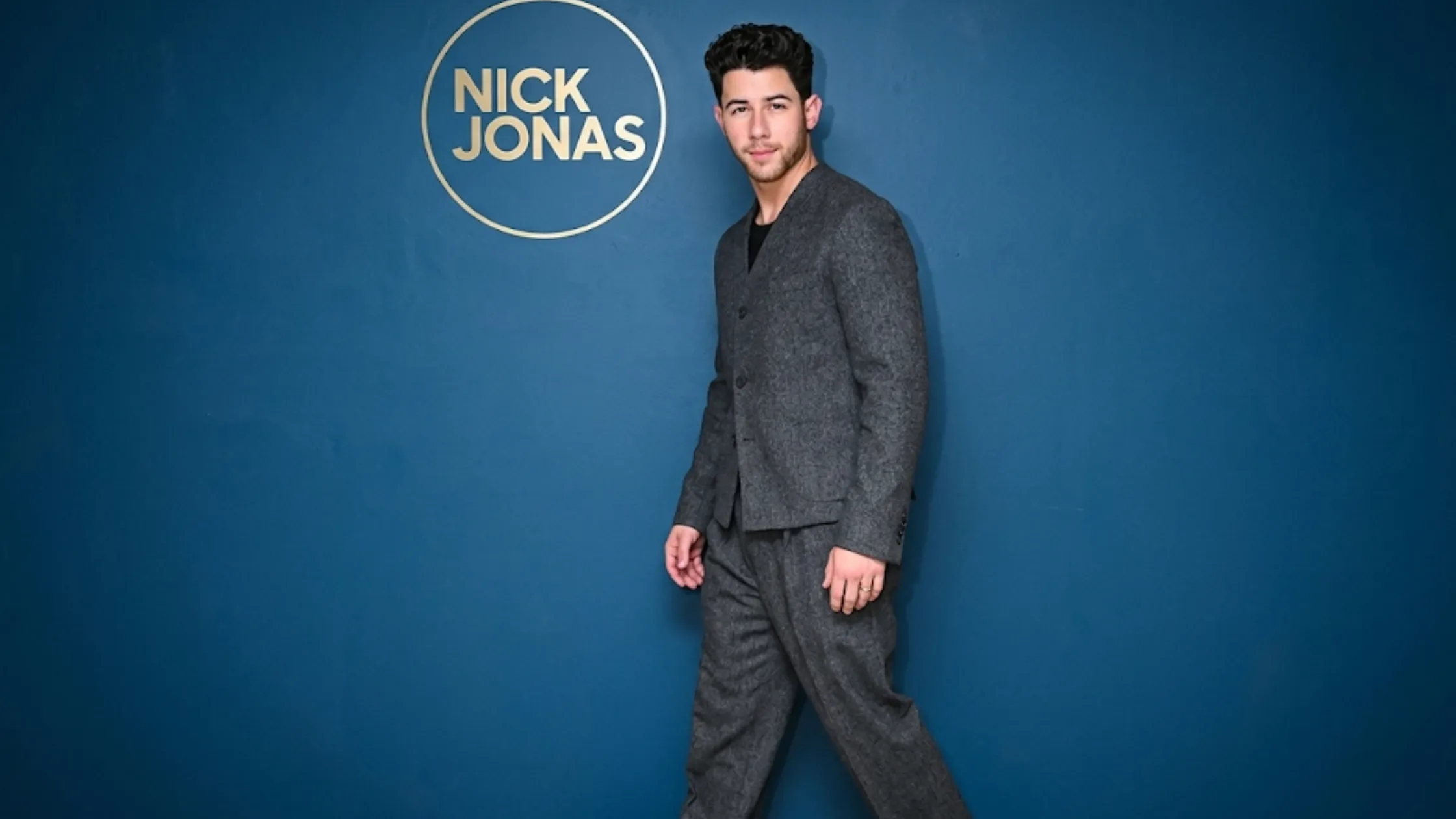 Nick Jonas Jimmy Fallon Season 13 2026 charcoal grey collarless cropped wool blazer interview look