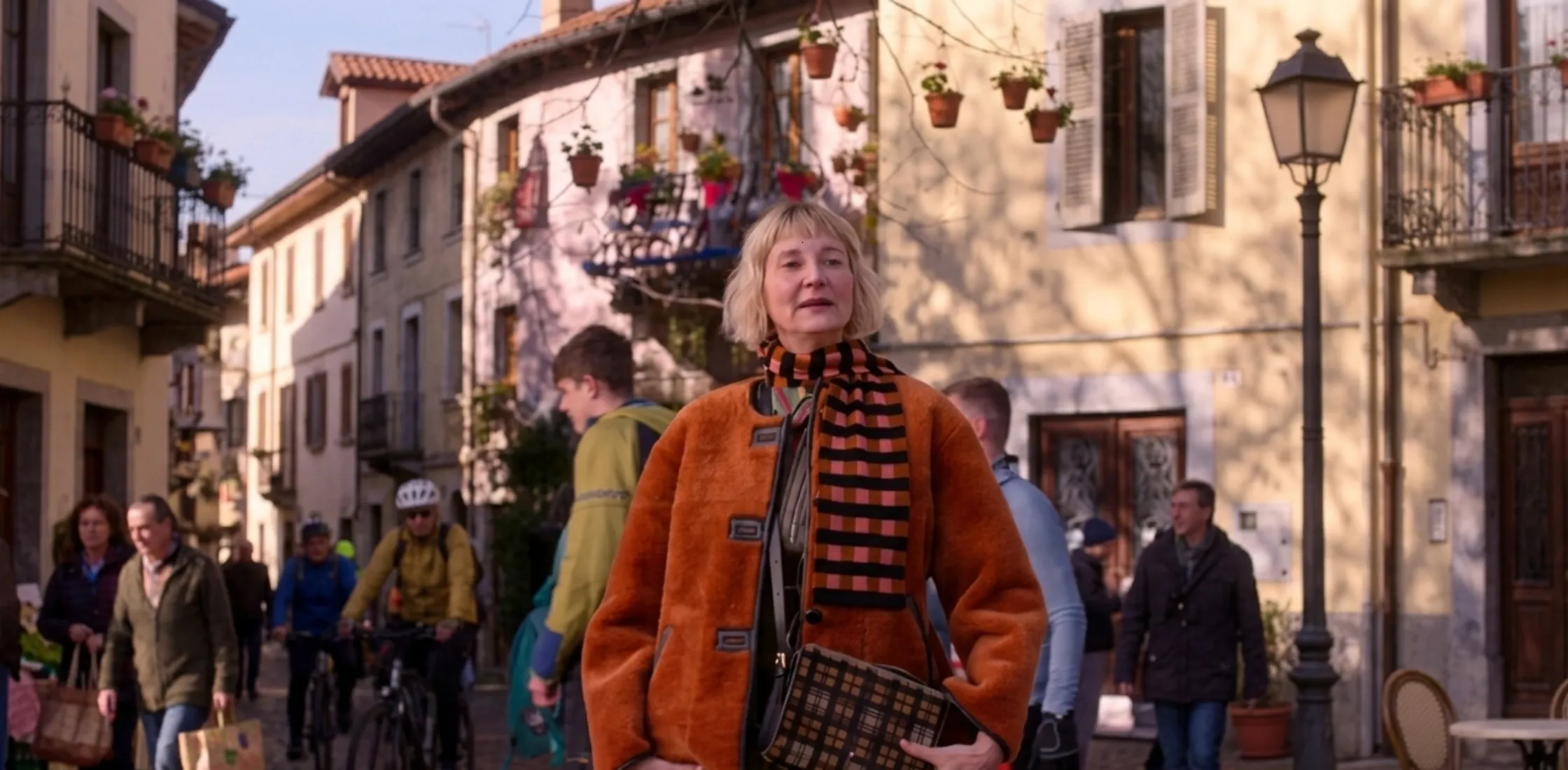 Kerri Kenney wearing orange faux fur reversible jacket from The Four Seasons Season 2 styled with earthy accessories and layered winter fashion look