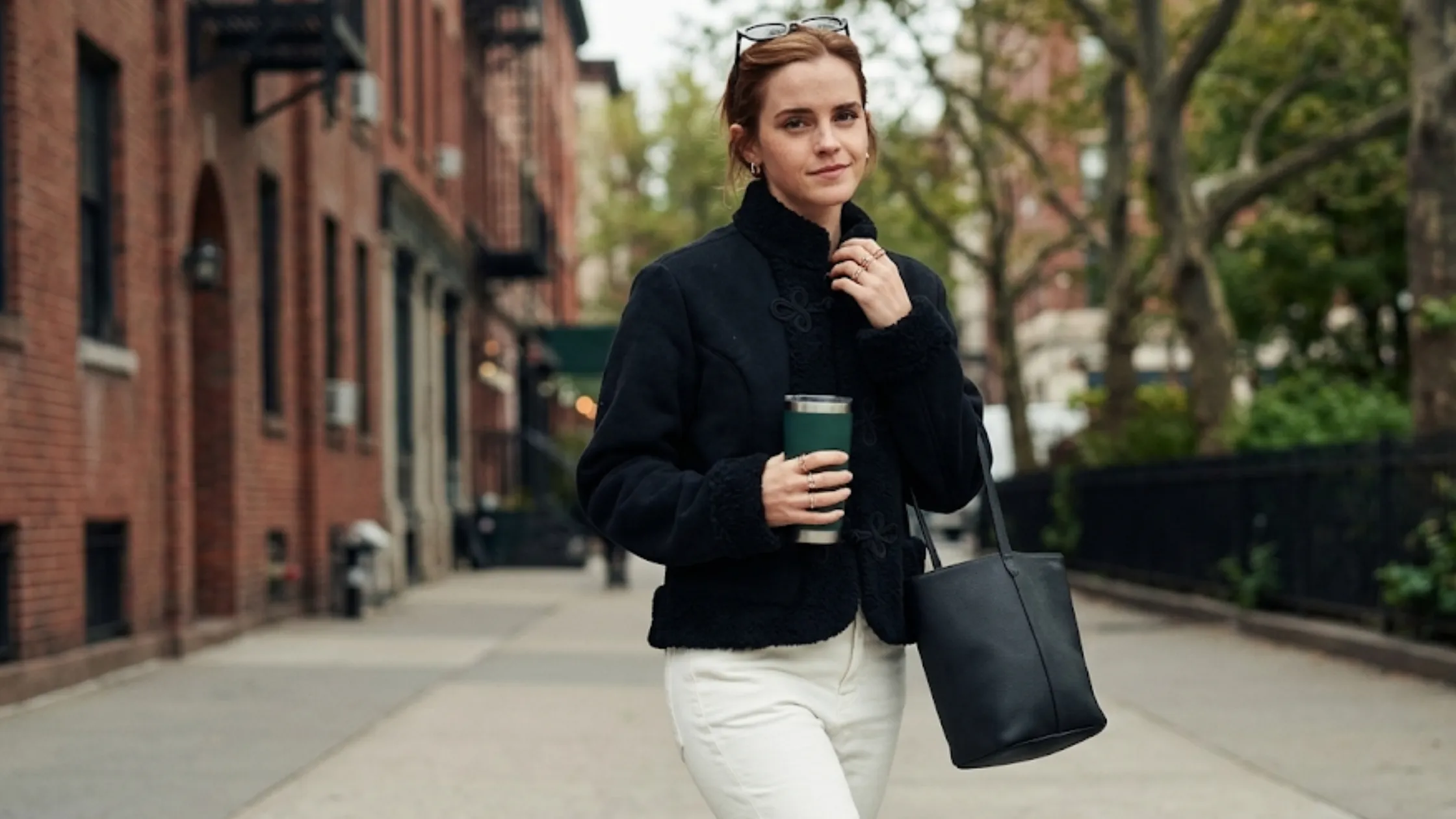 Emma Watson Los Angeles 2026 black cropped jacket with mandarin collar, faux shearling trim, and Chinese frog closure design