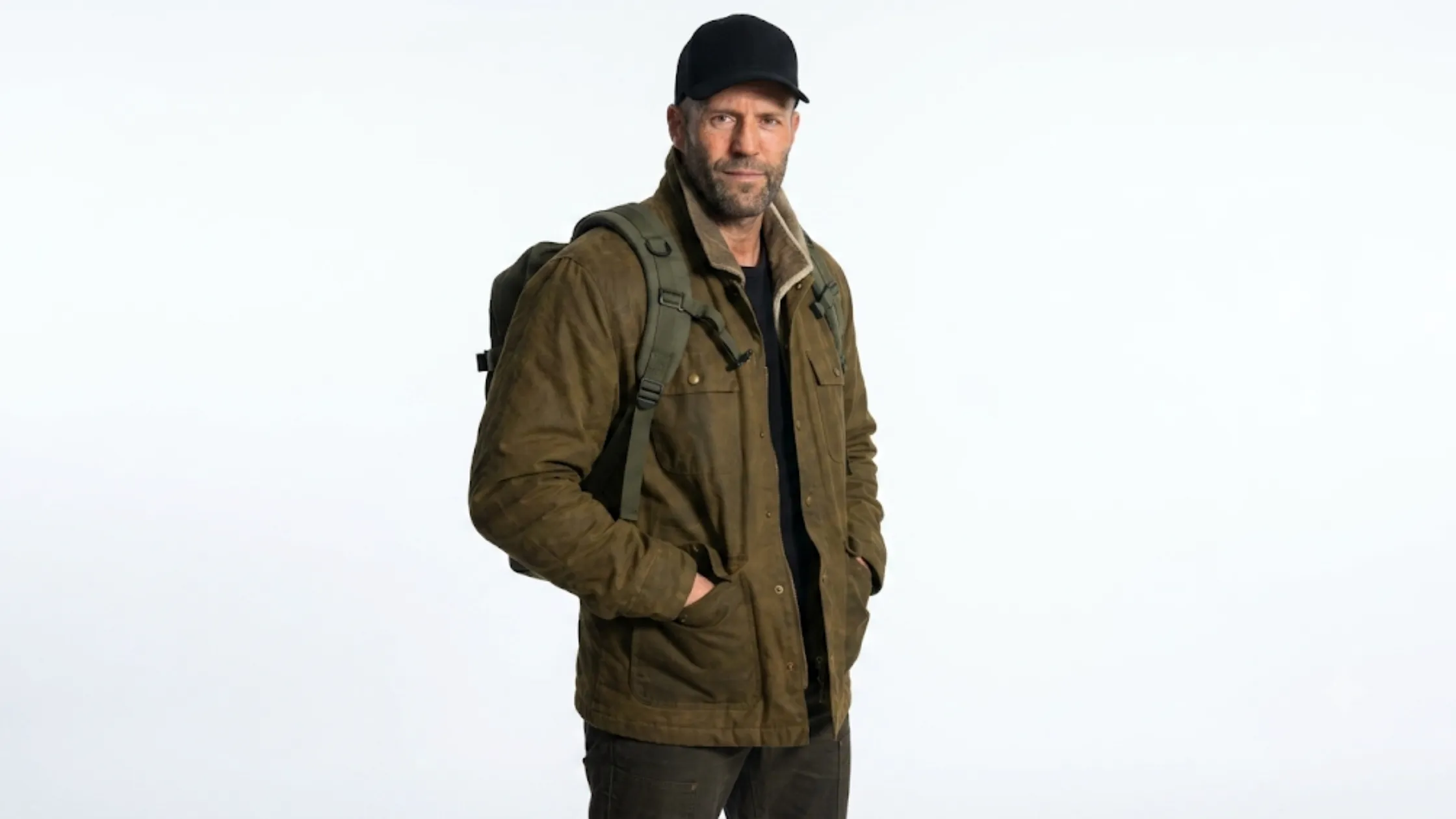 Jason Statham Mutiny 2026 dark olive green waxed cotton field jacket with corduroy collar and four-pocket utility design