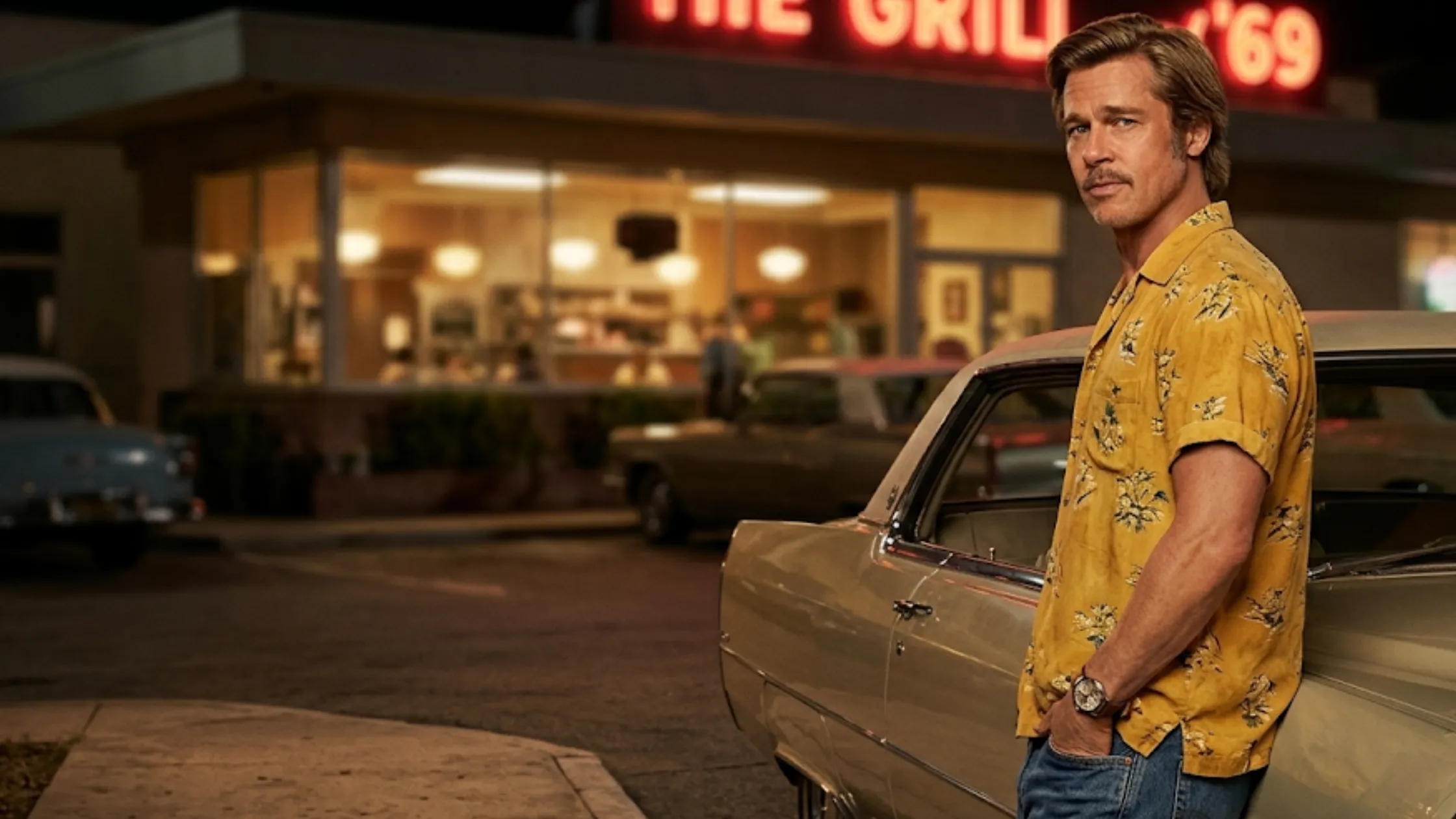 Brad Pitt Cliff Booth 2026 tropical yellow short sleeve camp collar shirt palm print vintage Hollywood cinematic outfit