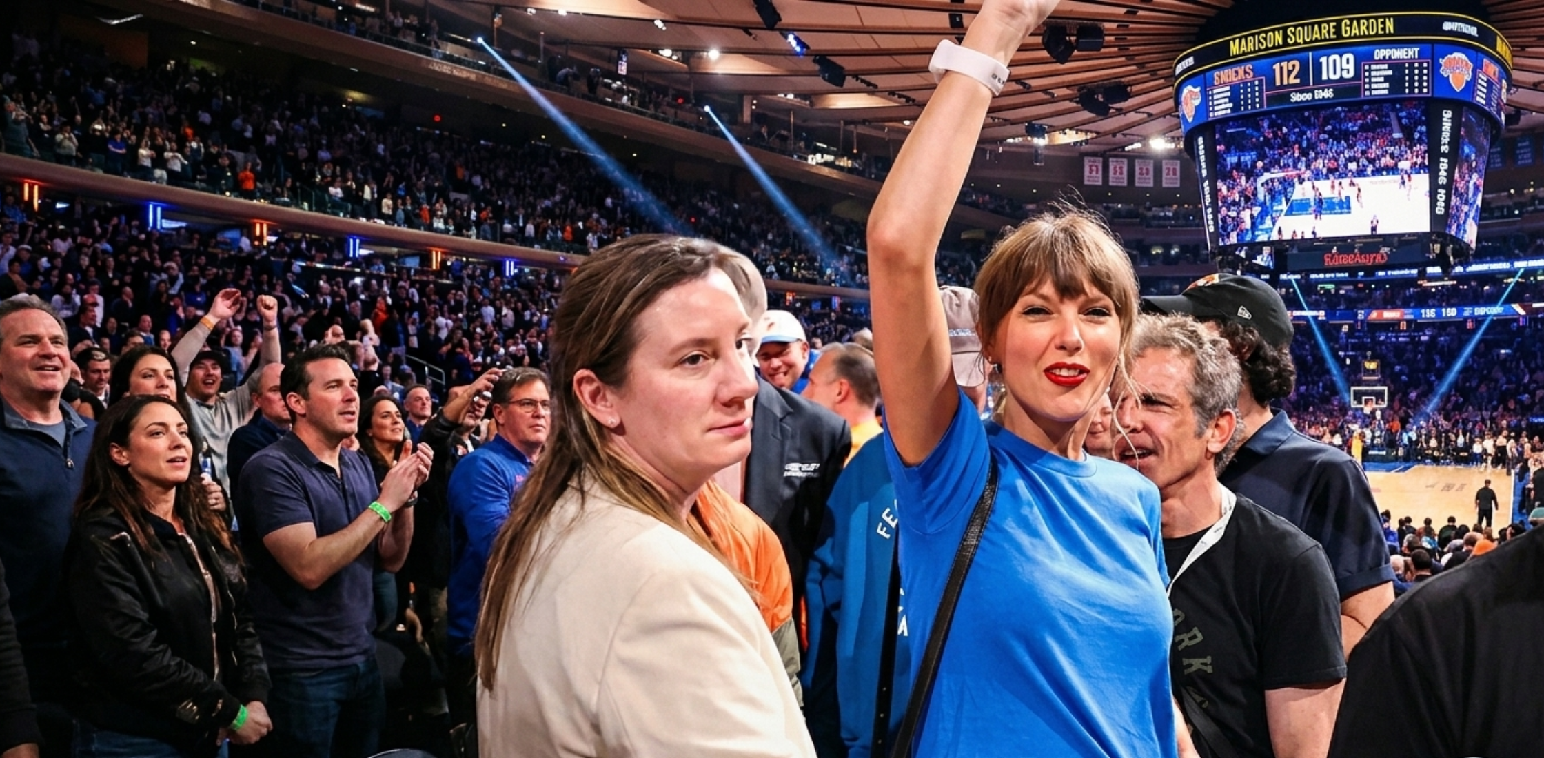 Taylor Swift wearing a royal blue cropped baby tee at Game 4 of the 2026 NBA Finals courtside, styled with dark denim and minimal accessories inside Madison Square Garden.
