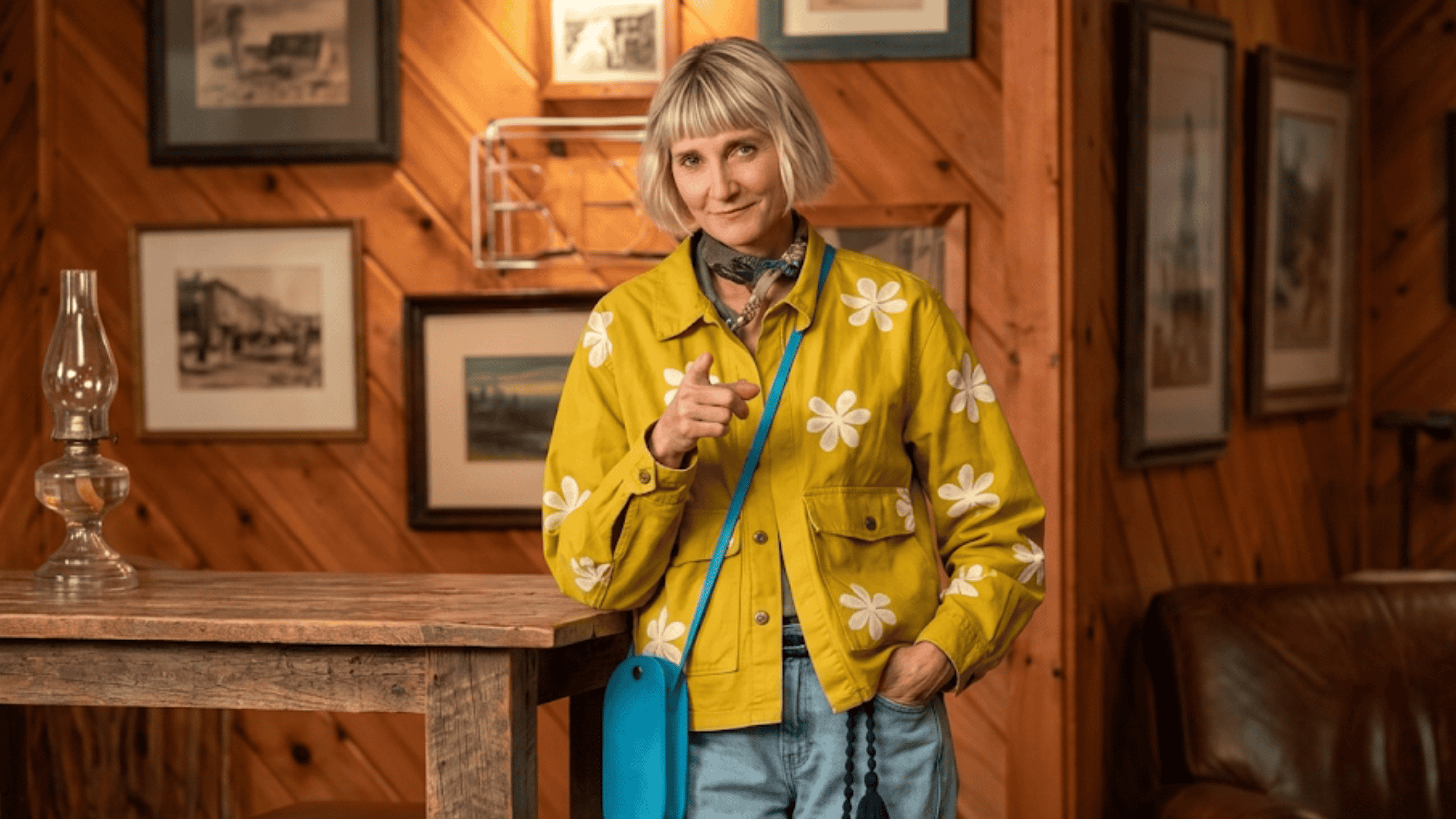 Kerri Kenney wearing the mustard yellow daisy print chore jacket with an all-over floral pattern from The Four Seasons Season 2.