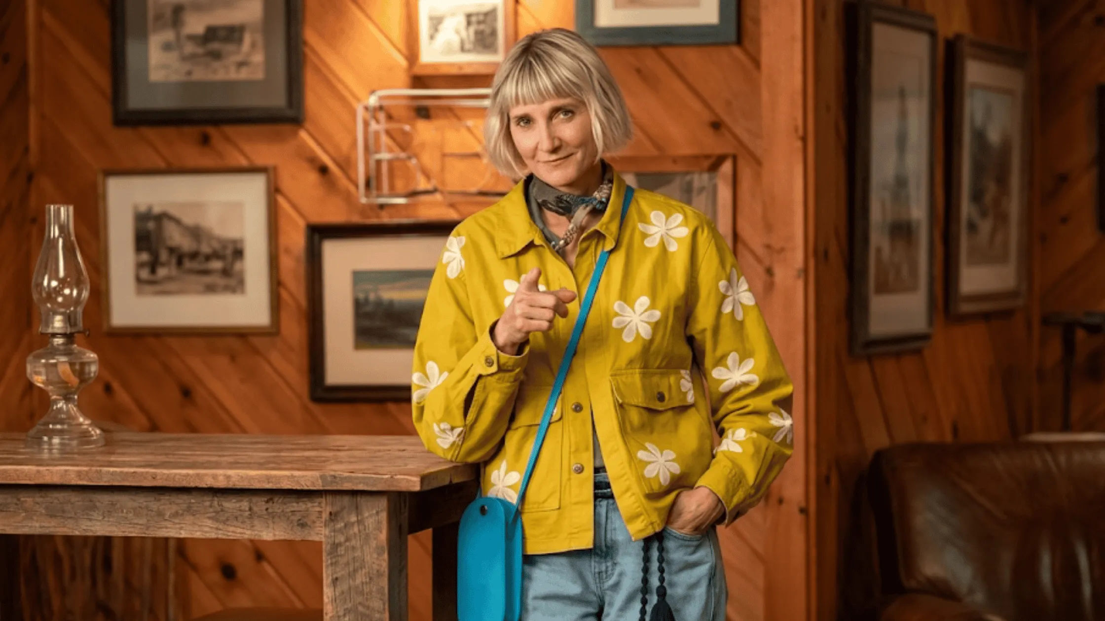 Kerri Kenney wearing the mustard yellow daisy print chore jacket with an all-over floral pattern from The Four Seasons Season 2.