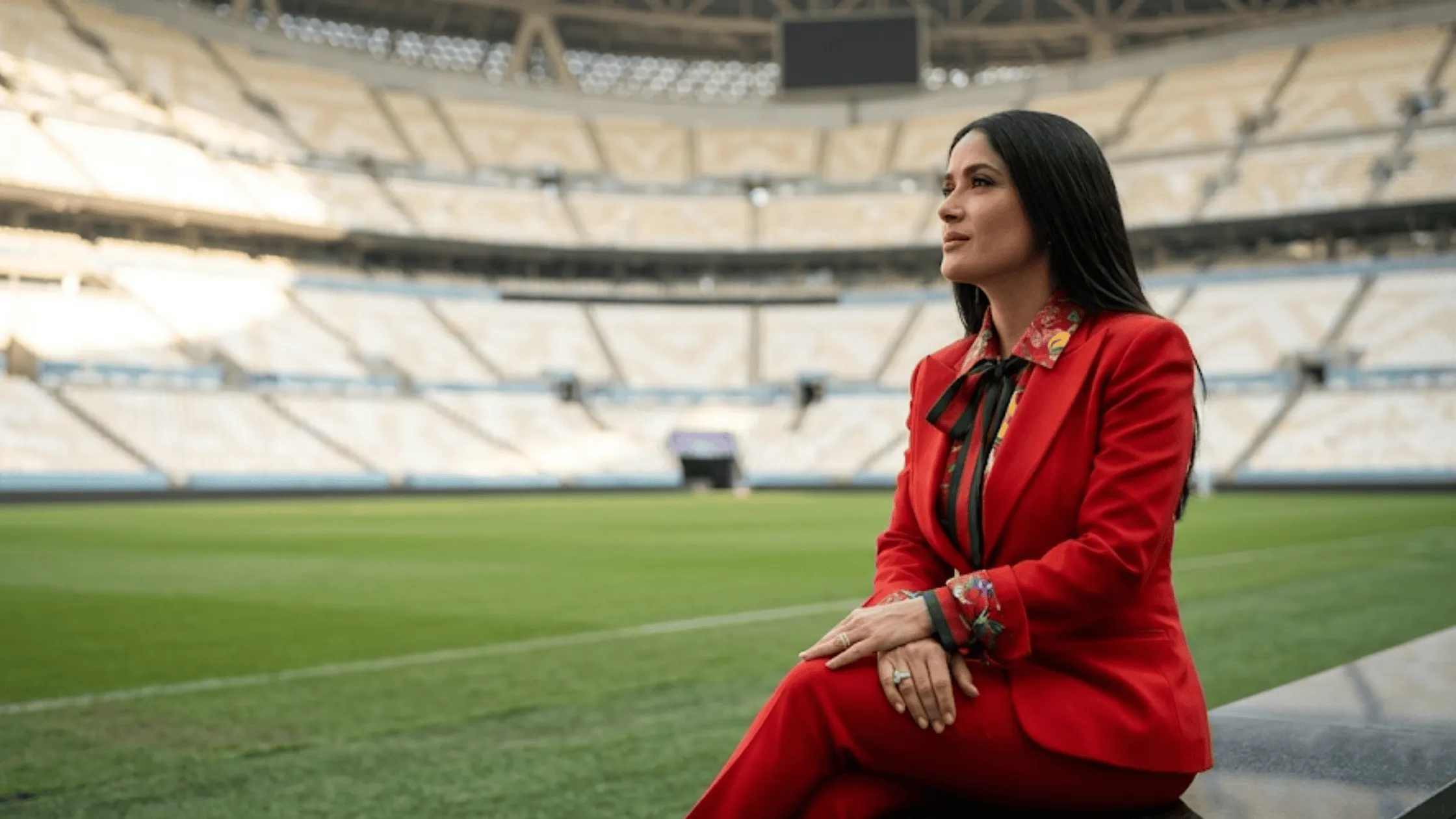 Salma Hayek FIFA World Cup 2026 opening ceremony crimson red tailored slim-fit blazer with split fold-back cuffs.
