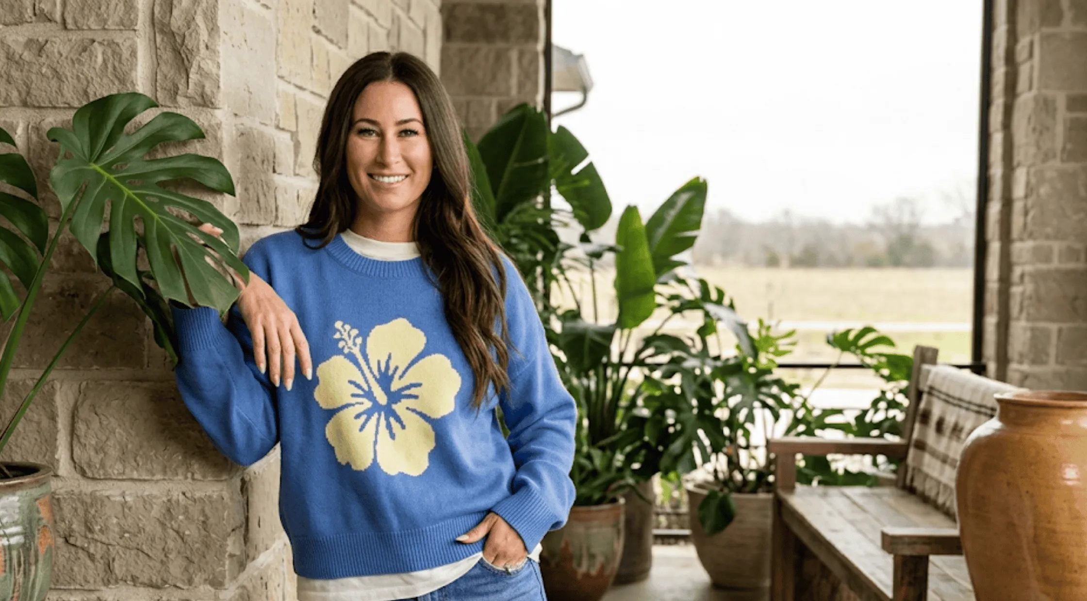 Battle on the Beach S05 Tristyn Kalama cream oversized crewneck sweatshirt with a large blue hibiscus flower print.