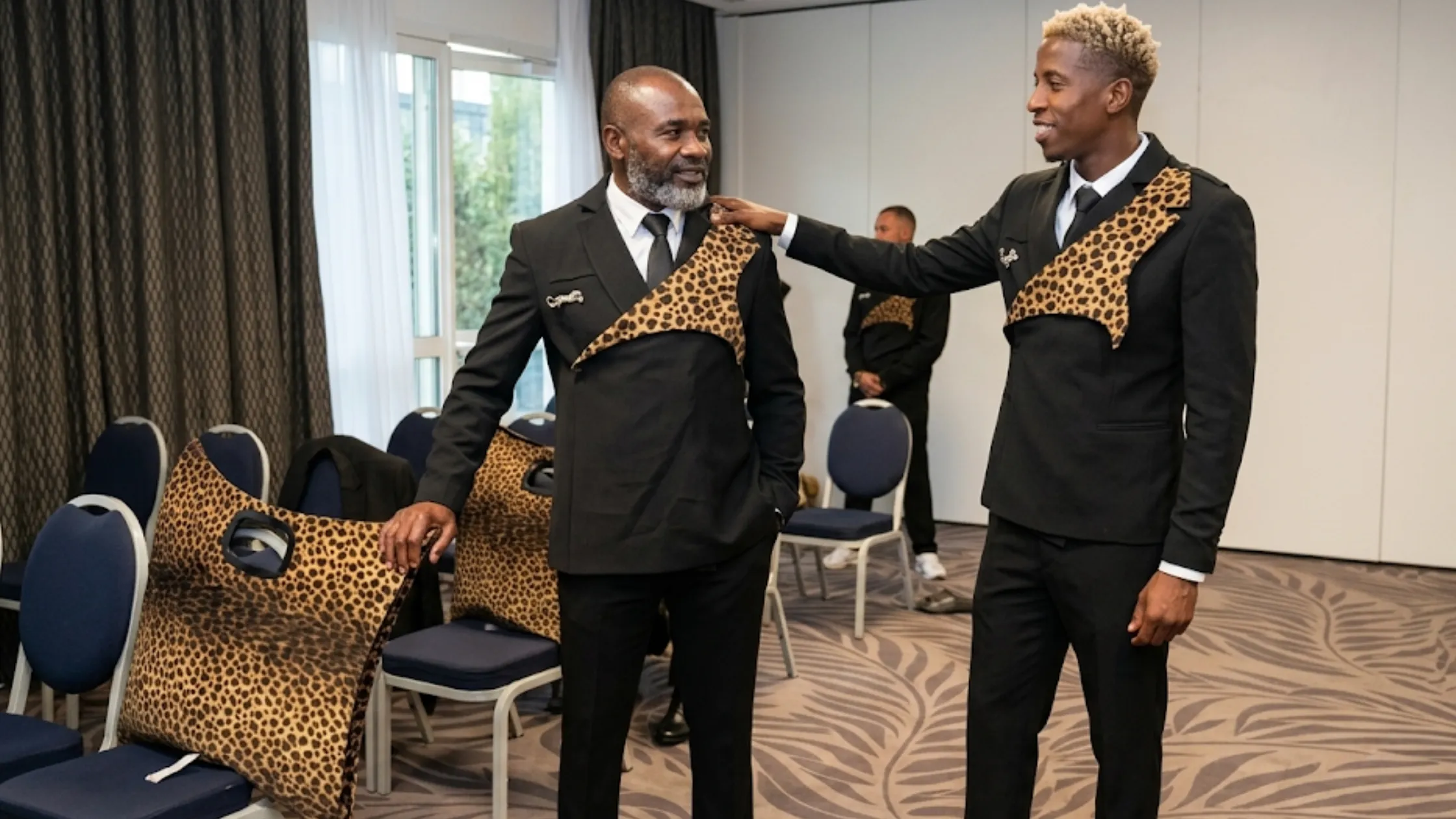 DR Congo FIFA World Cup 2026 Léopard Suit with asymmetrical leopard-print shoulder drape, black tailored double-breasted silhouette, and runway-style cultural design