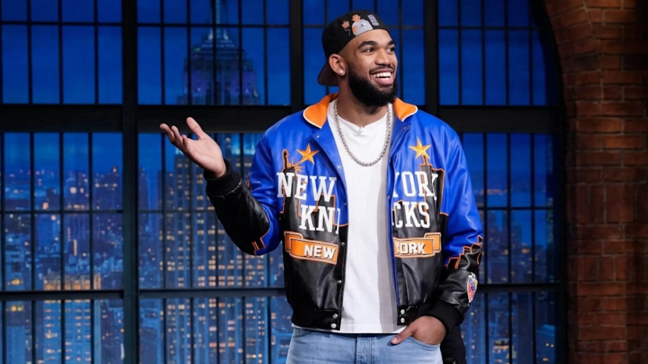 Karl-Anthony Towns New York Knicks varsity leather jacket from The Tonight Show S13 with blue, black, and orange color-block design and Statue of Liberty graphic.