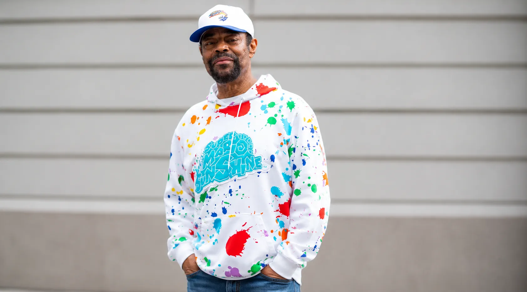 Walt Frazier New York Knicks Championship Parade hoodie featuring white base with multicolor paint splatter and Super Mario Sunshine graphic in bold streetwear design