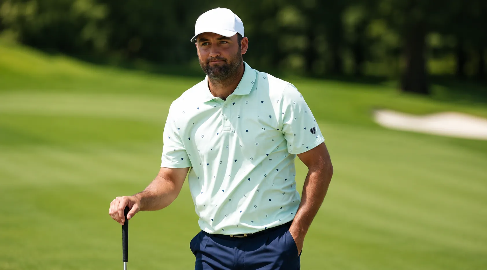 Scottie Scheffler Memorial Tournament mint green golf polo shirt featuring navy micro geometric shield print, structured collar, and athletic performance fabric design inspired by elite golf fashion.