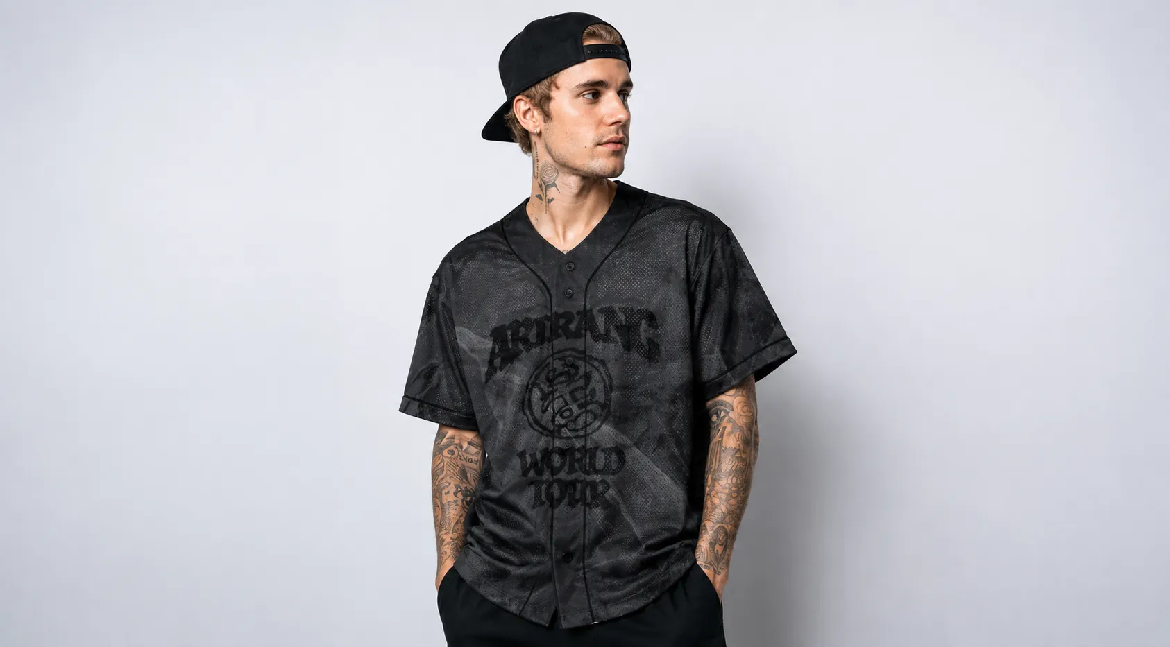 Charcoal grey V BTS Arirang World Tour baseball jersey with black piping, featuring “ARIRANG WORLD TOUR” front graphic, crest emblem, and back print with V and number 95 in a marble mesh design.