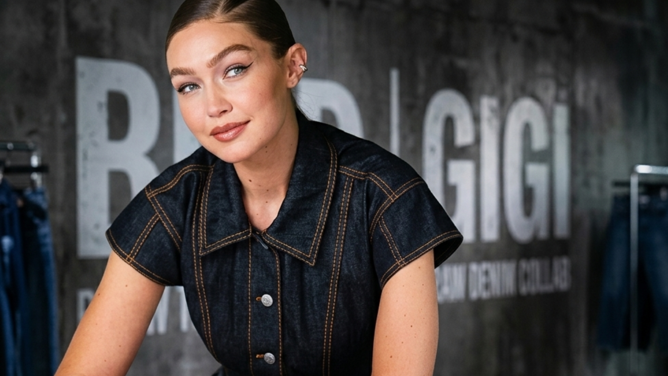 Gigi Hadid Maybelline NYC Soho dark denim jumpsuit look with structured tailoring and bold copper stitching