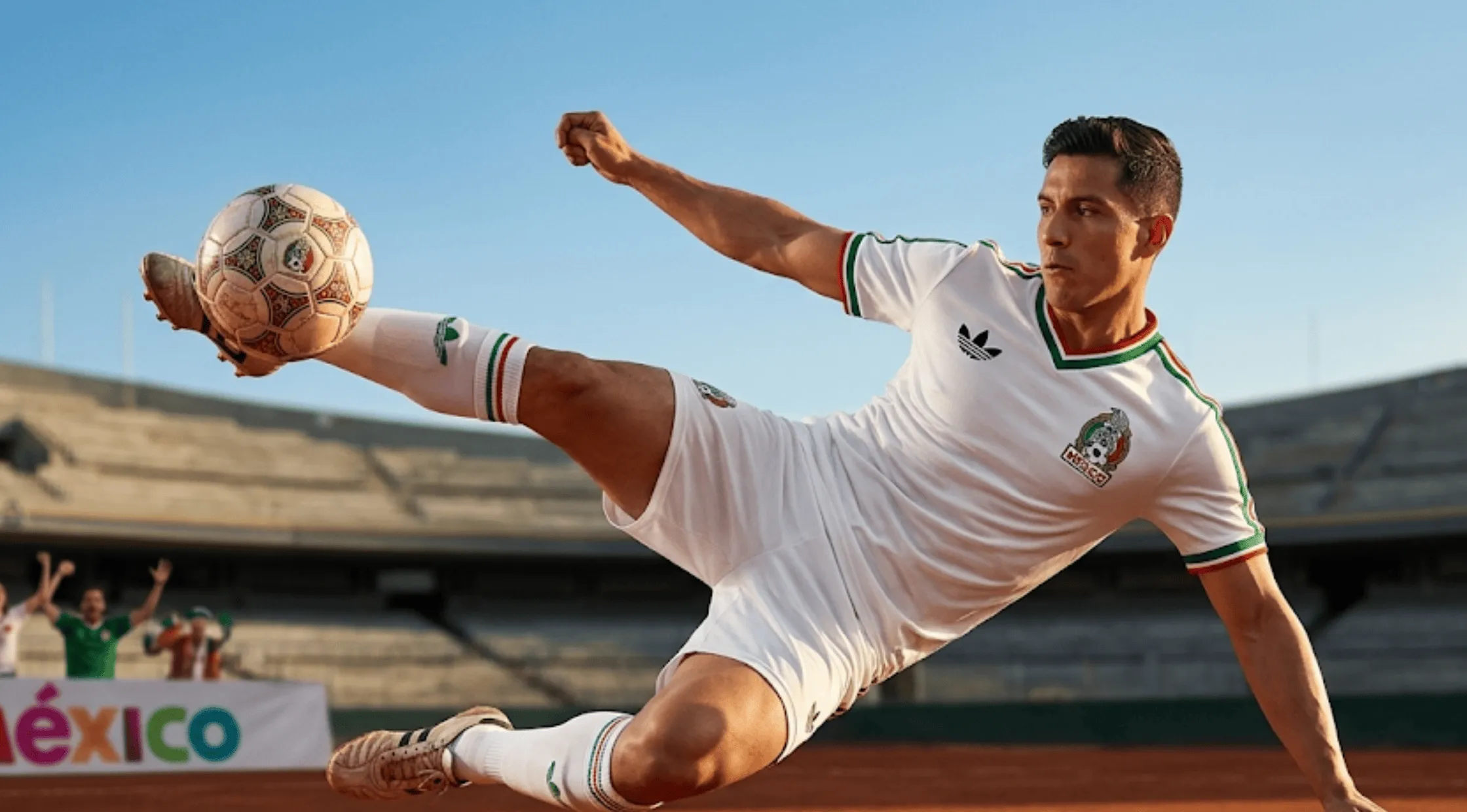 A person wearing the white Mexico 2026 away jersey featuring a green and red V-neck collar, matching sleeve cuffs, and a black Adidas trefoil logo.