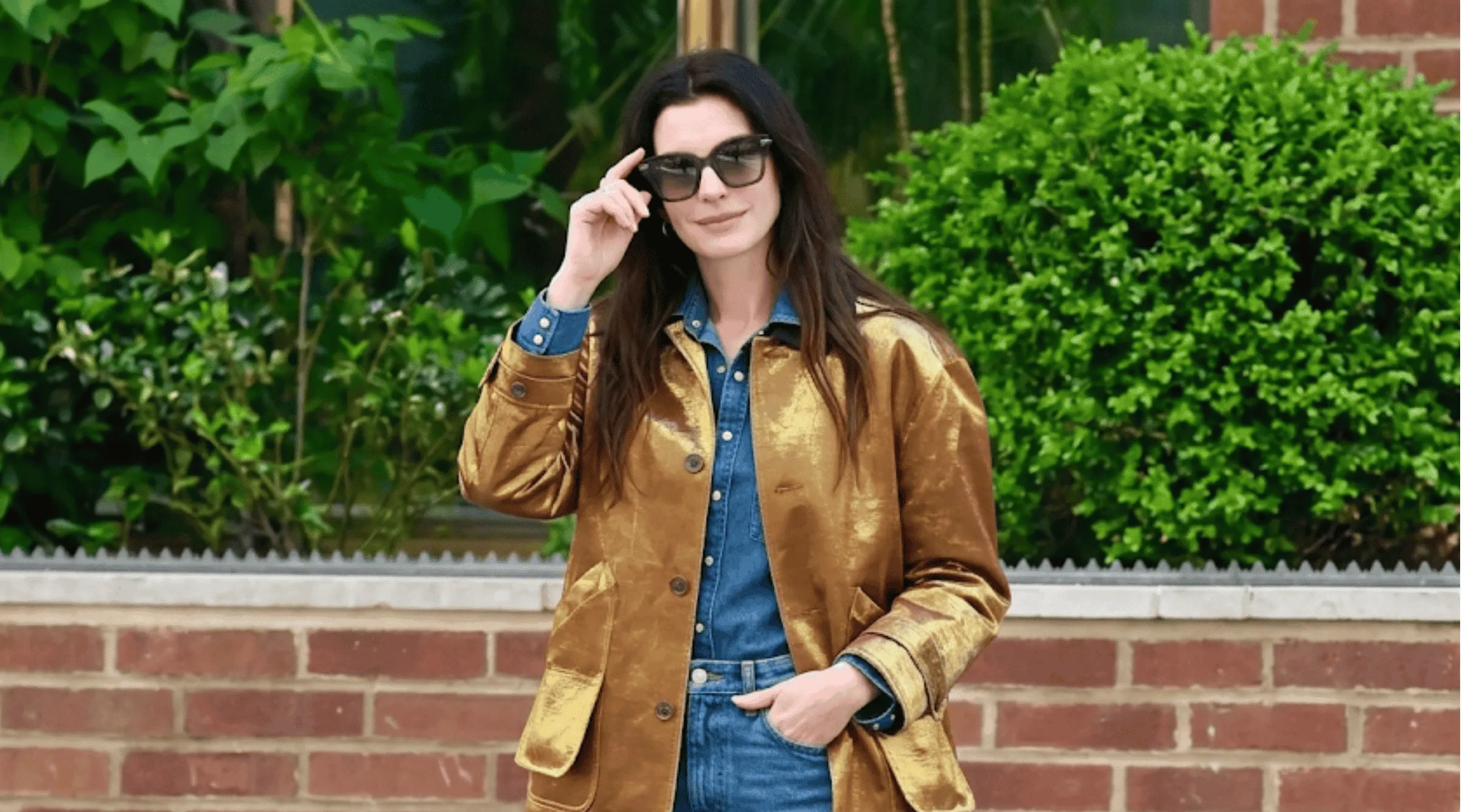 Anne Hathaway wearing the oversized bronze-gold metallic barn jacket with large front patch pockets and a pointed collar while out in New York City.